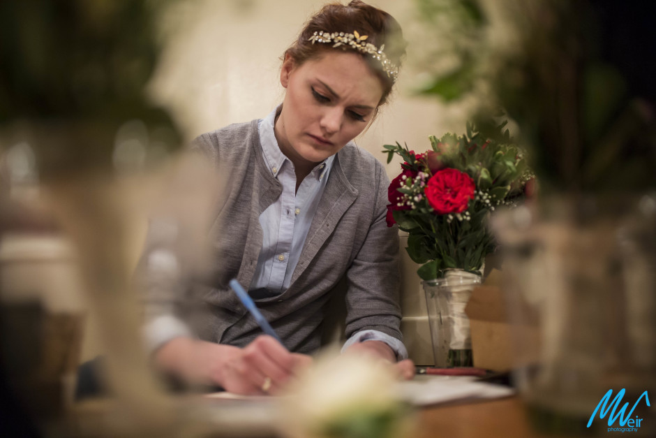 bride writing a letter to groom on wedding day