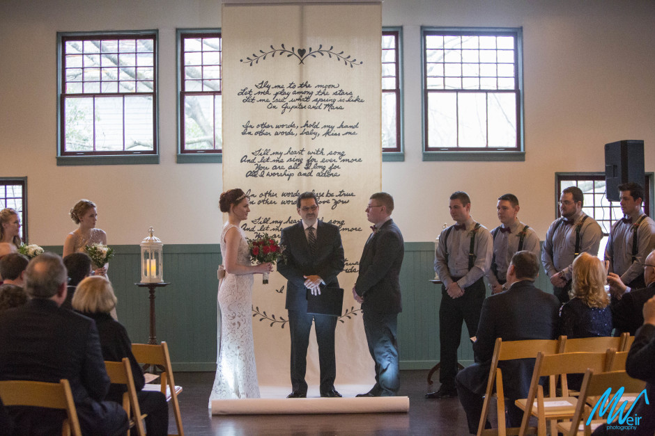 bride and groom exchanging vows at trolley barn venue