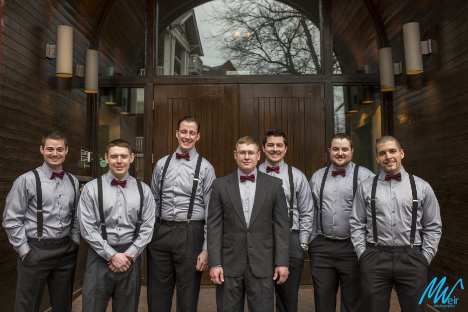 groomsmen wearing bow ties and suspenders