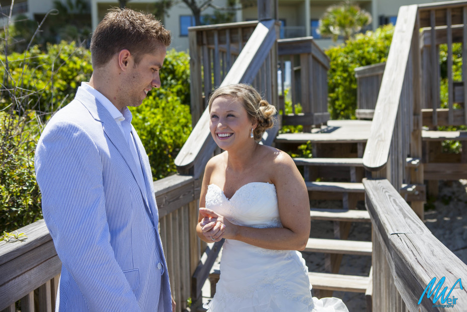 bride laughing during their first look on the boardwalk