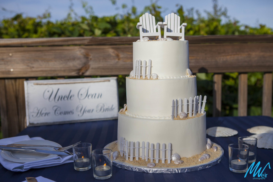 beach themed wedding caked with picket fences and beach chairs as cake toppers