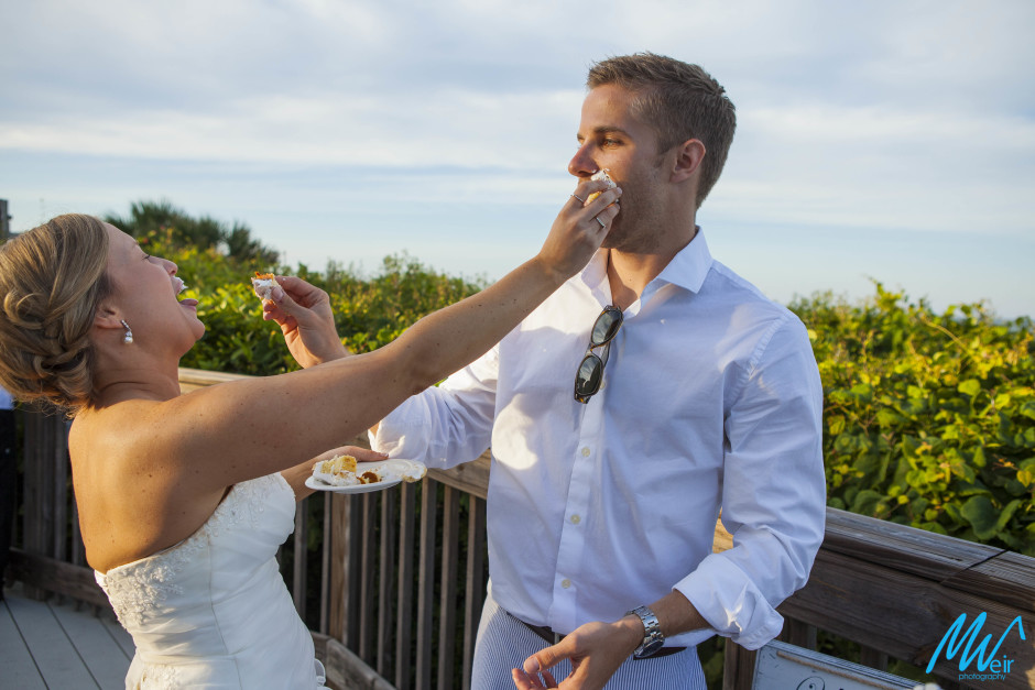 bride and groom smash wedding caked in each others face