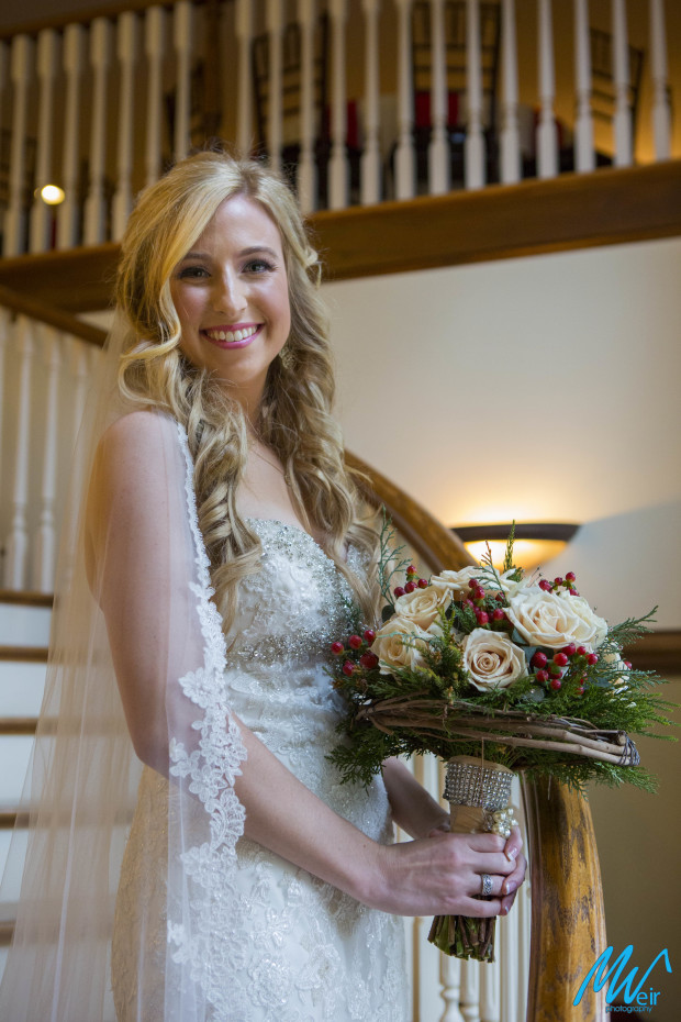 winter bride standing on grand staircase