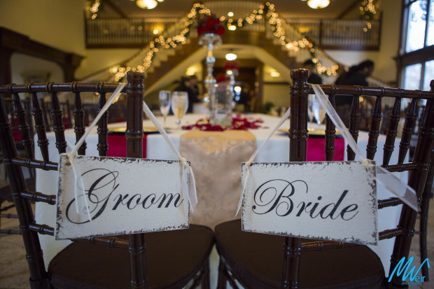 bride and groom signs on reception chairs