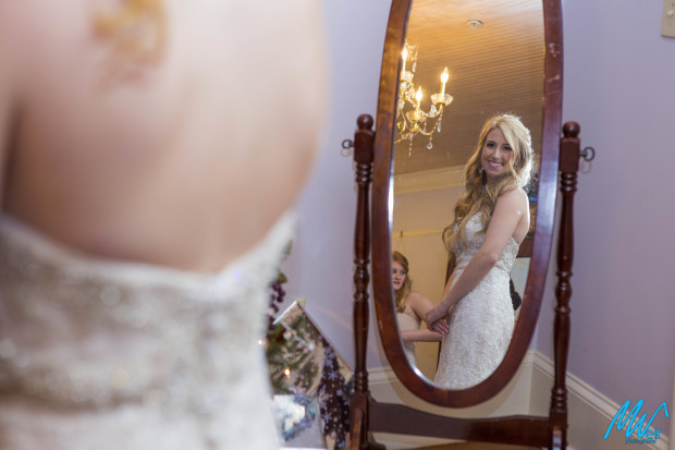 bride looks at herself in the mirror