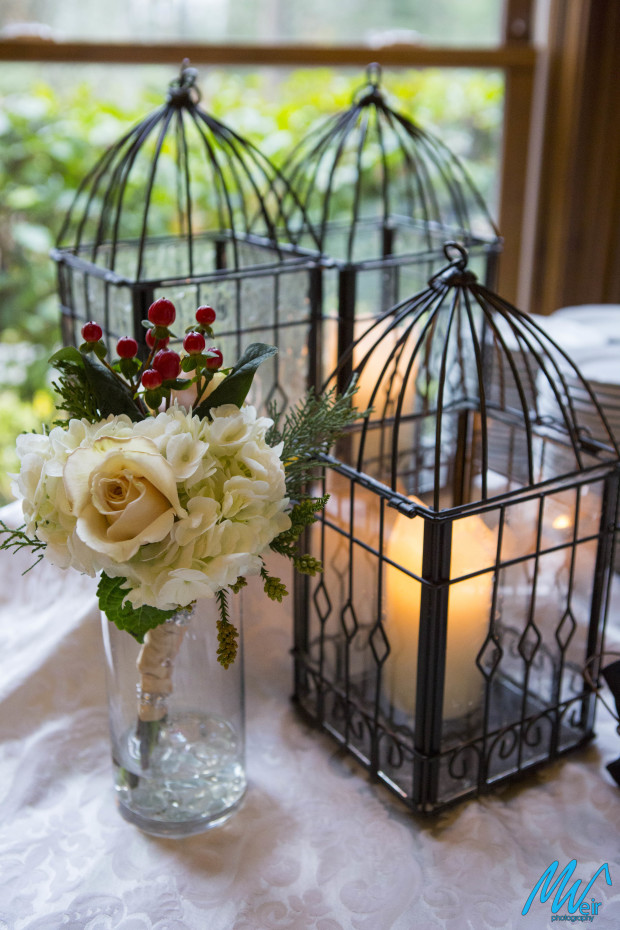 white rose tossing bouquet next to a lantern