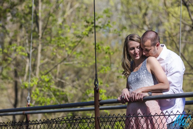 bride and groom on a suspension bridge