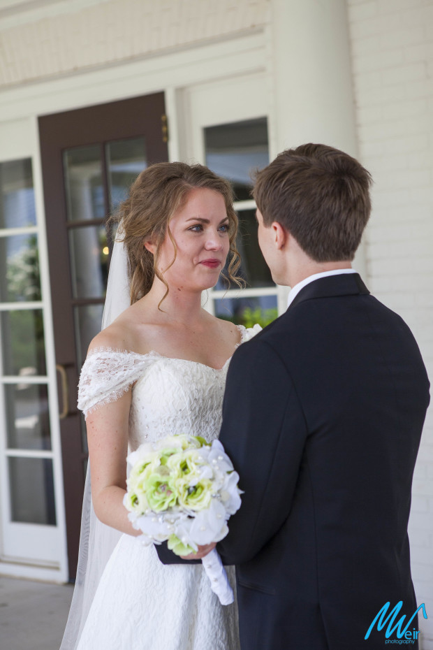 bride and groom looking at each other during first look