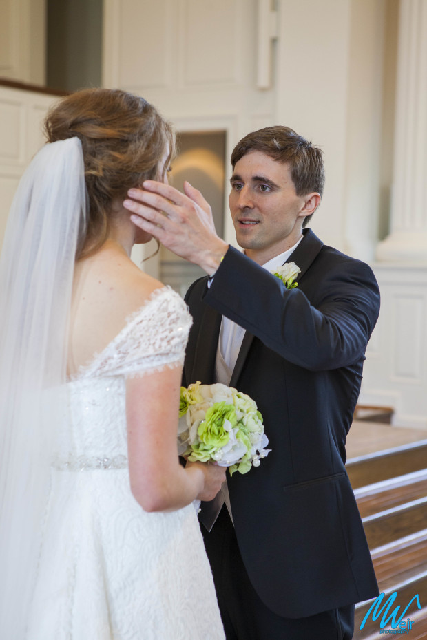 groom wiping away his brides tears