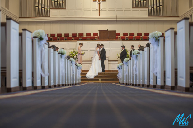 bride and groom at the church alter during prayer during their wedding ceremony