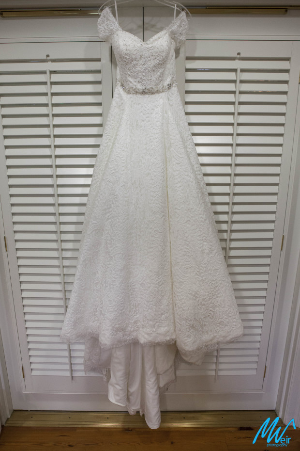 lace wedding dress on a hanger