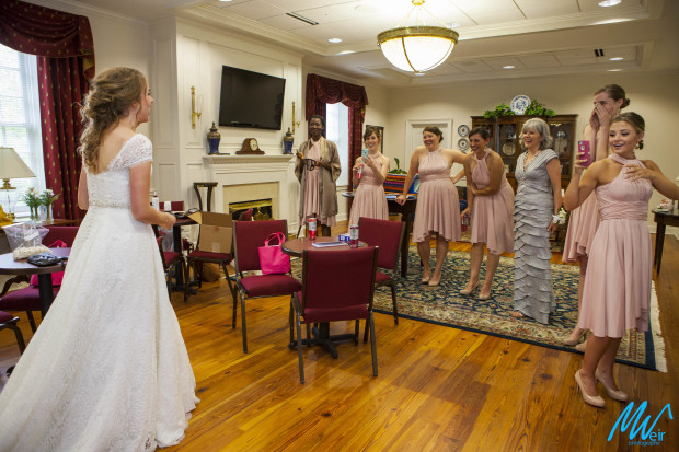 bridesmaids seeing bride for the first time in her wedding dress