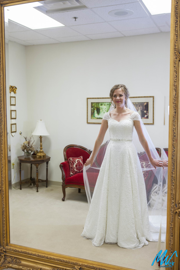 bride admiring herself in the mirror