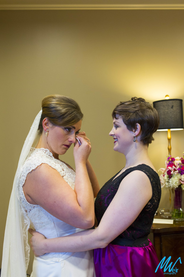bride cries with excitement with her sister