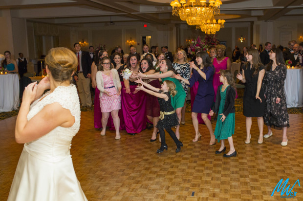 single ladies try to catch brides bouquet