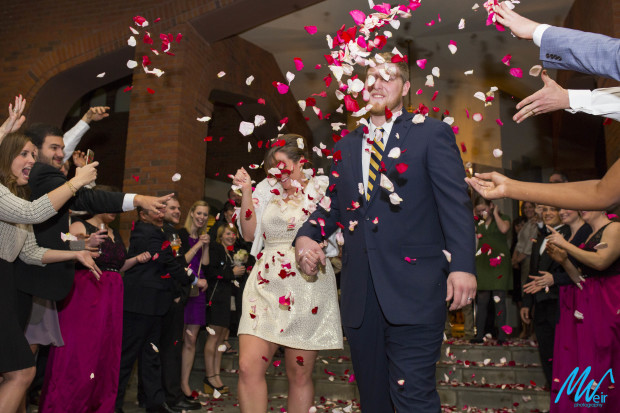 Bride and groom grand exit with rose petals thrown at them