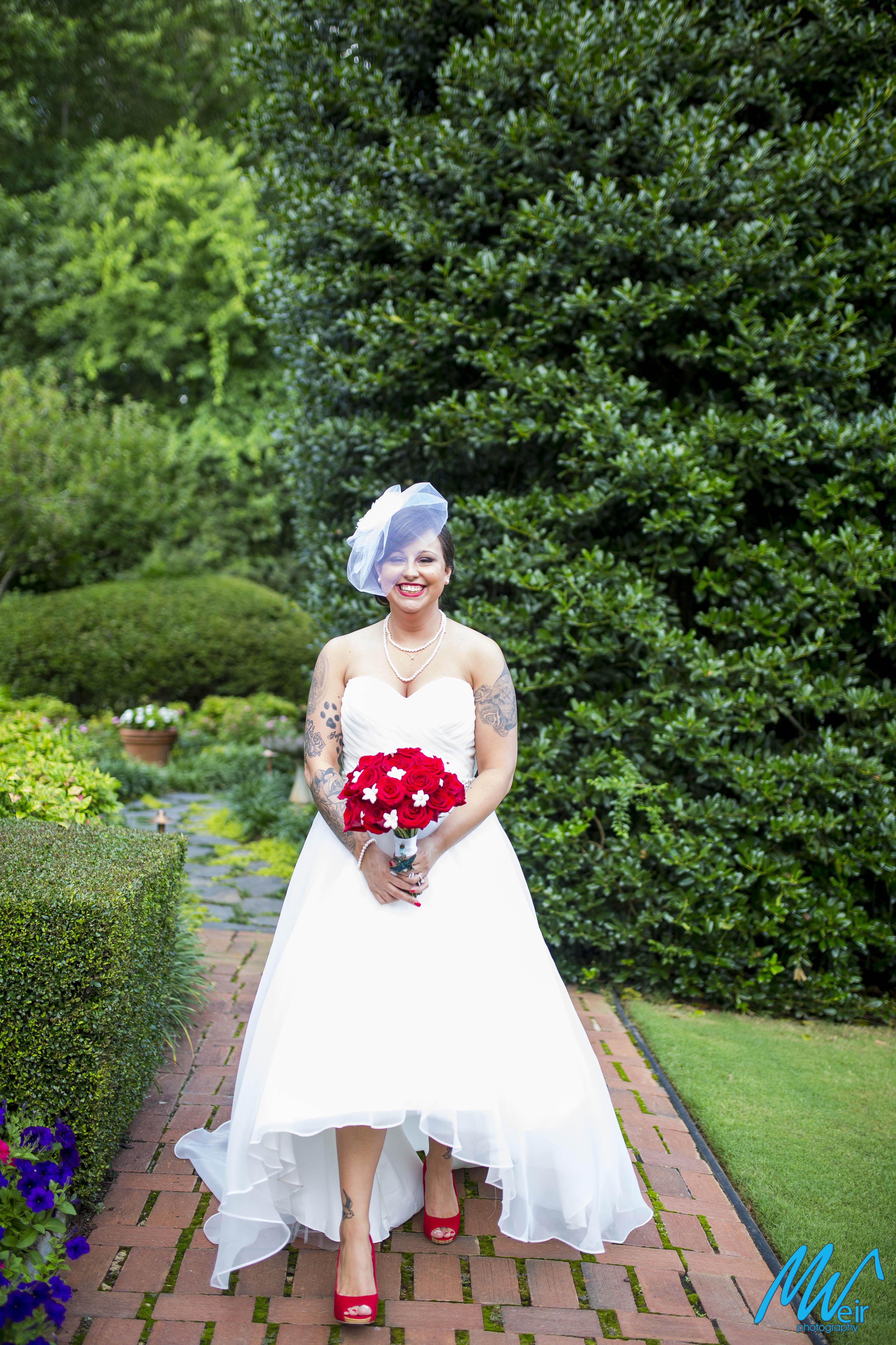 bride with red rose bouquet