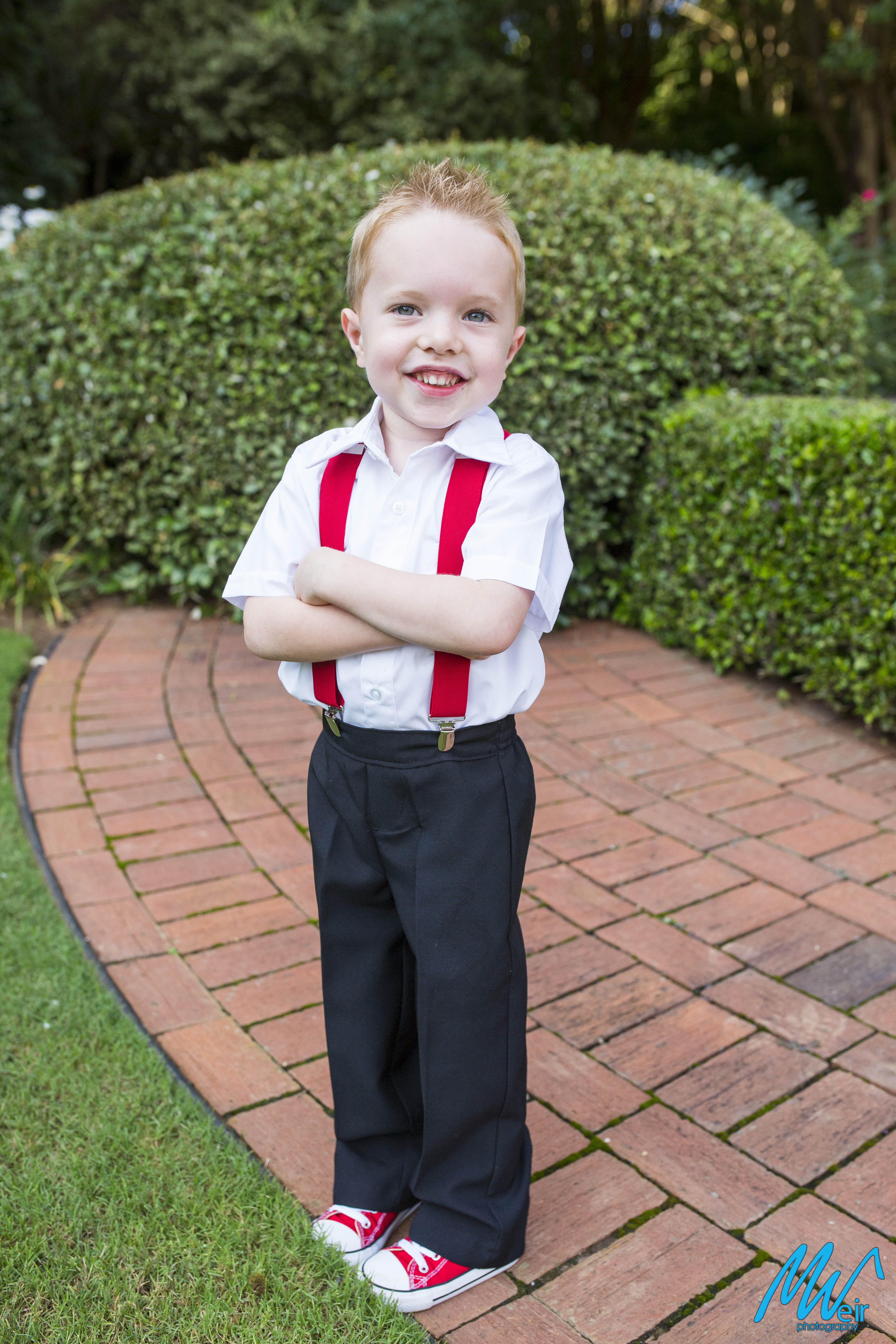 small boy with red suspenders