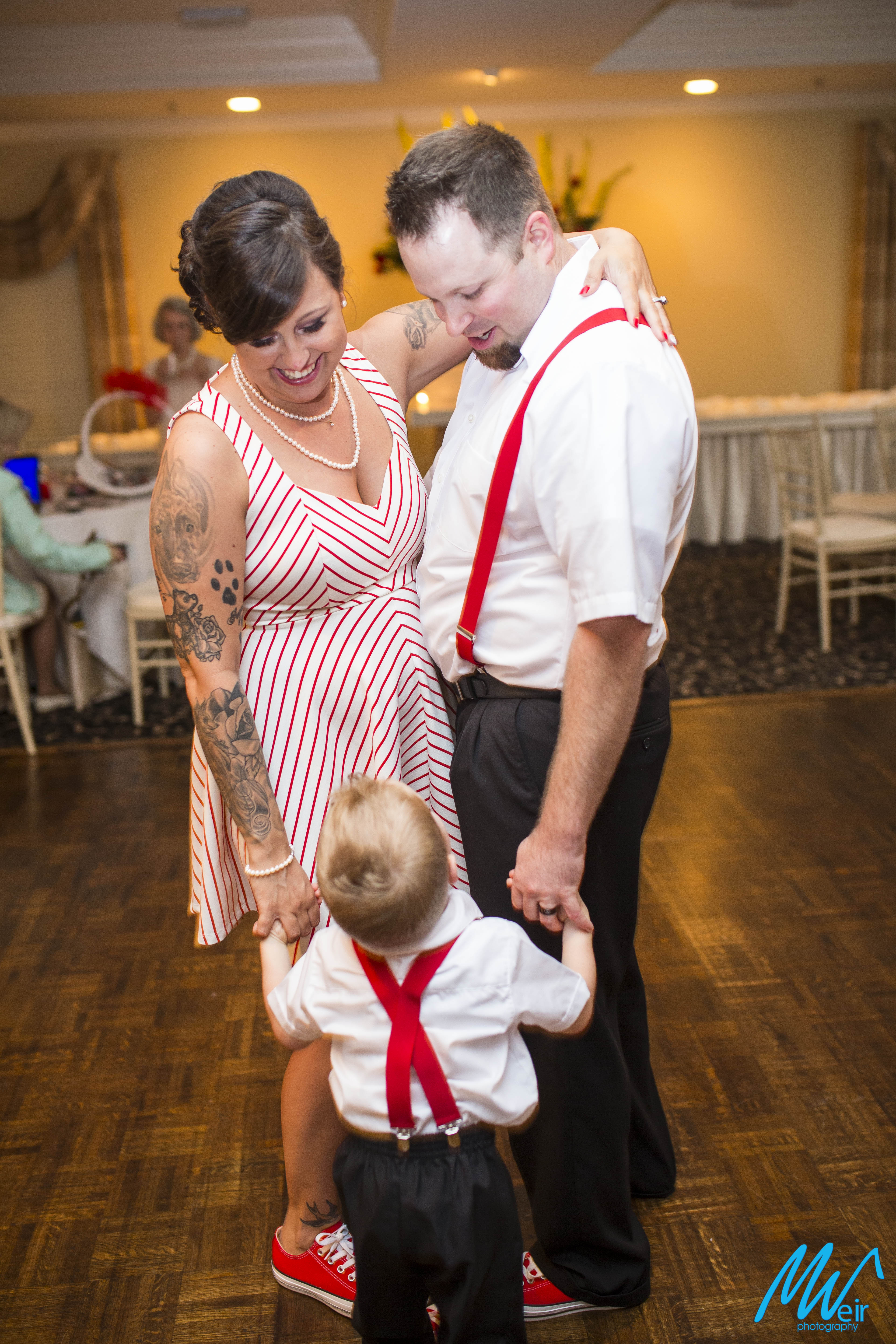 bride and groom dance with son