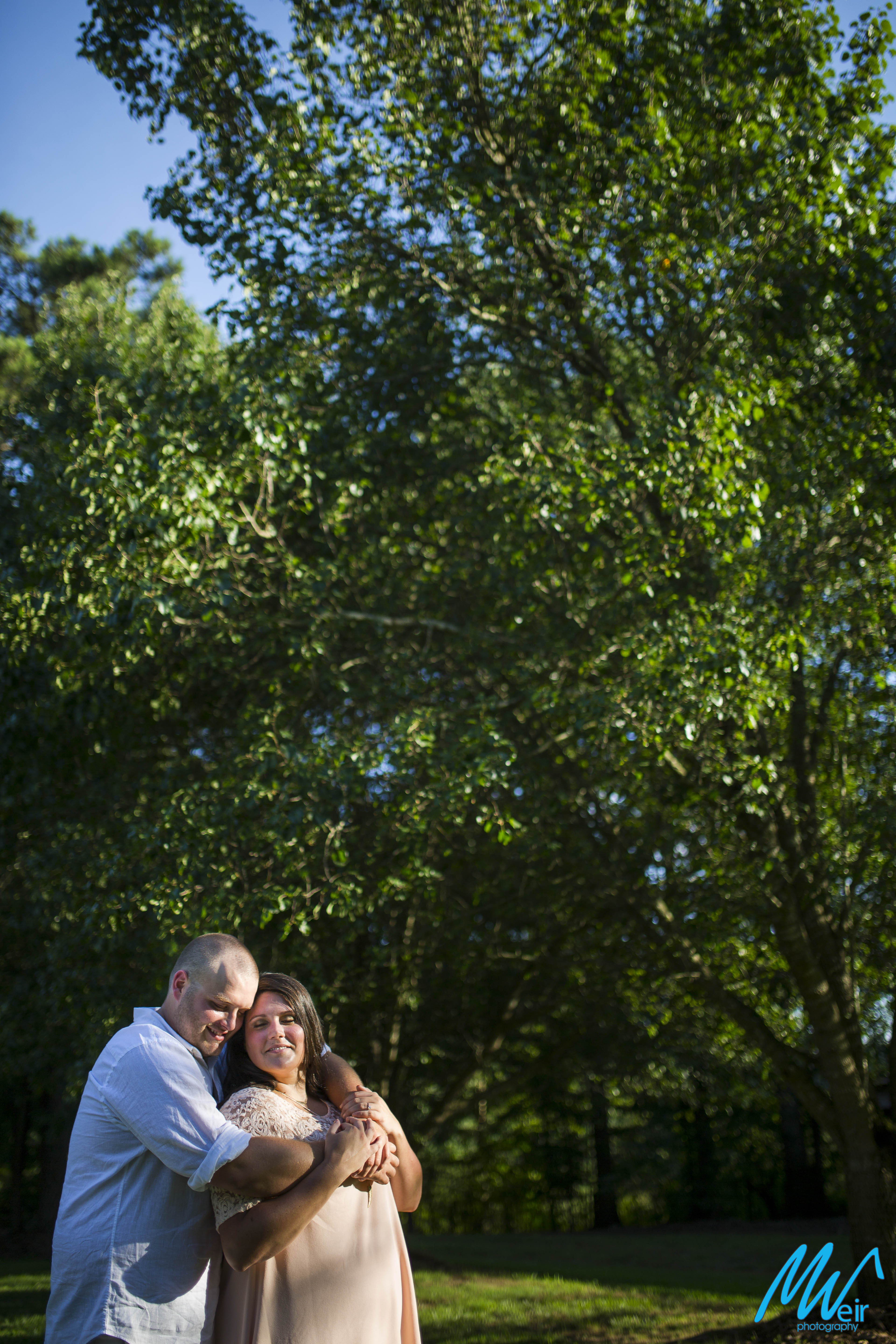 bride and groom enjoy quiet moment under trees