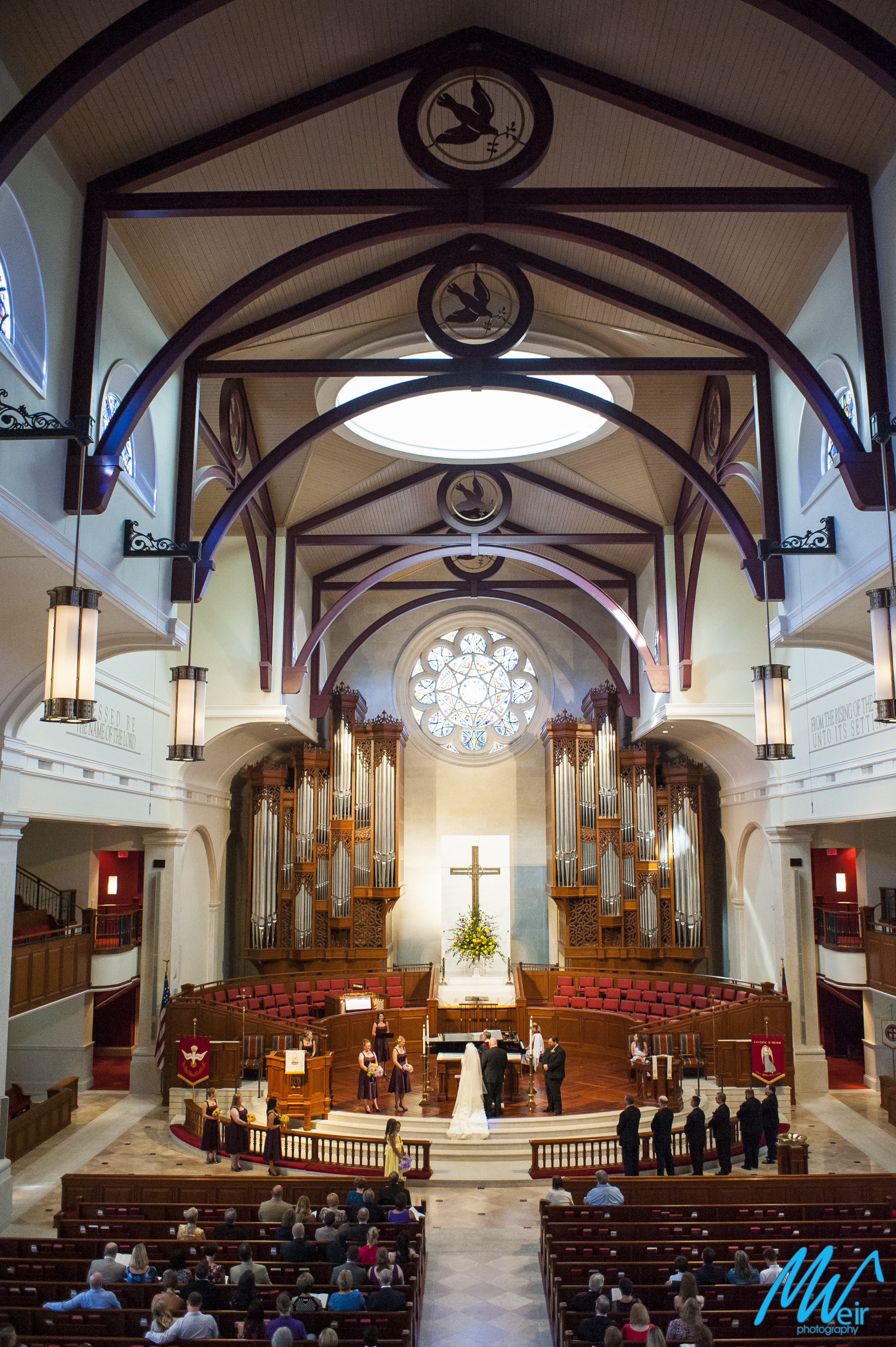 wide angle shot of bride and groom getting married in a church