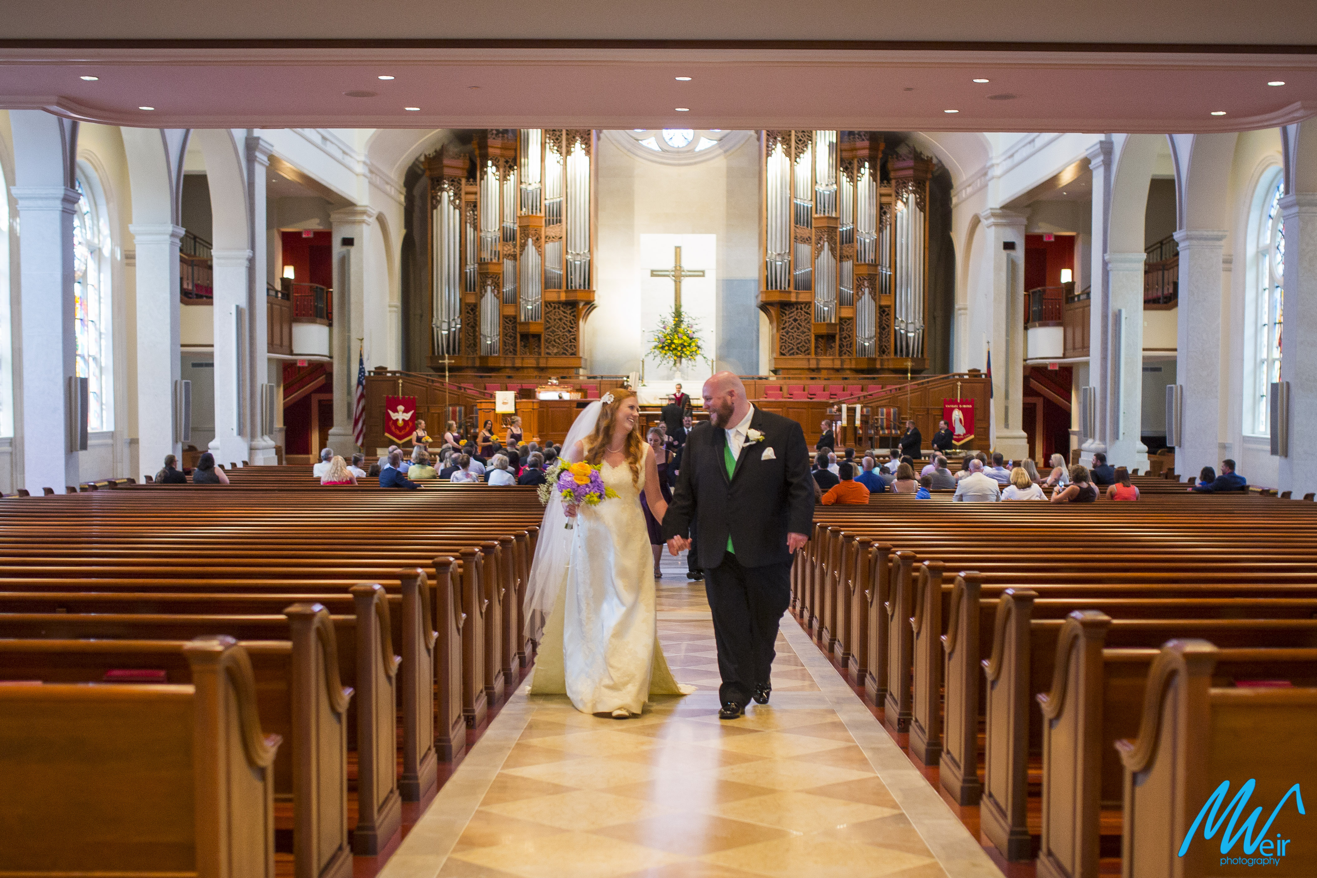 bride and groom walking back up aisle after getting married