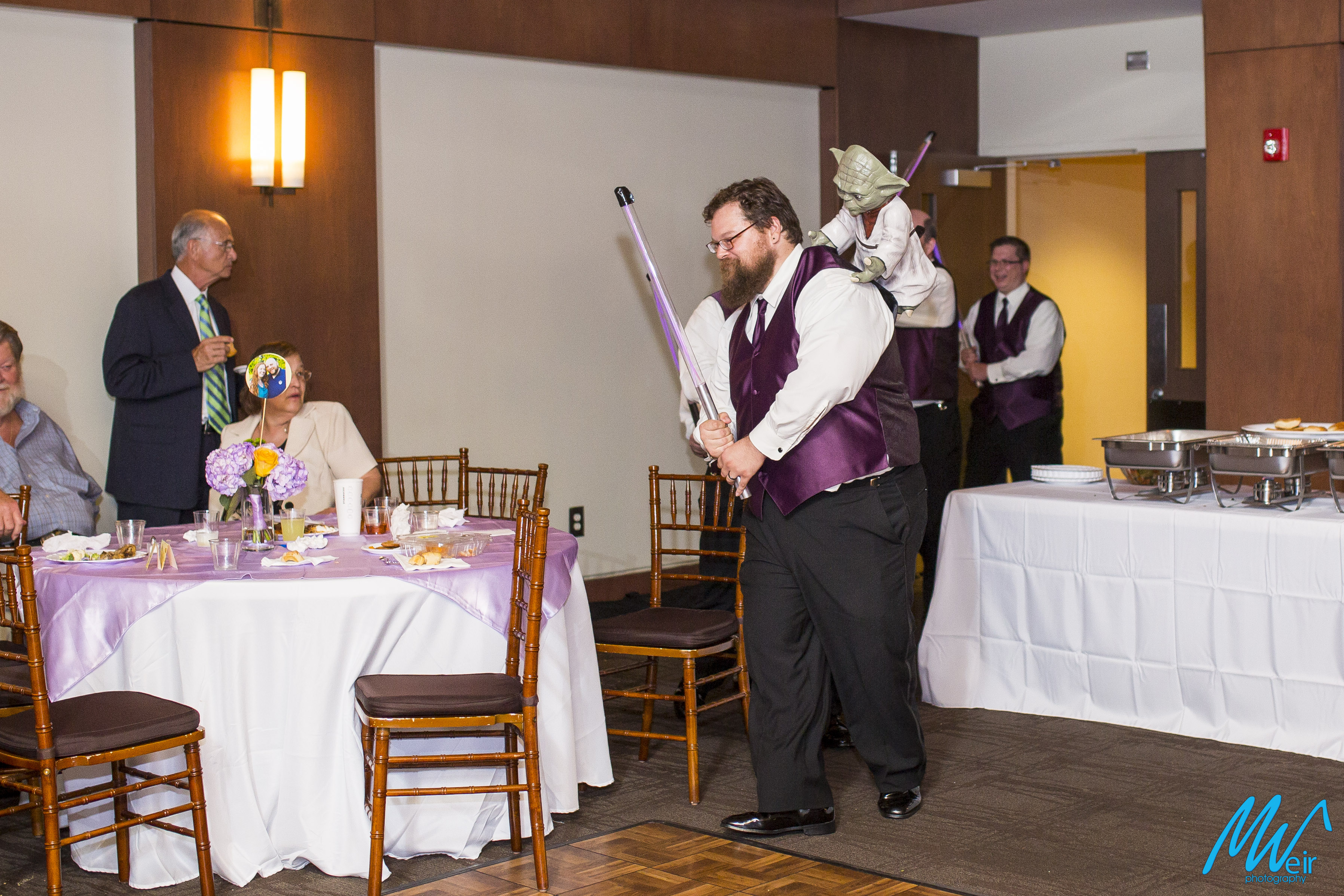 groomsmen surprise groom with star wars light sabers and yoda