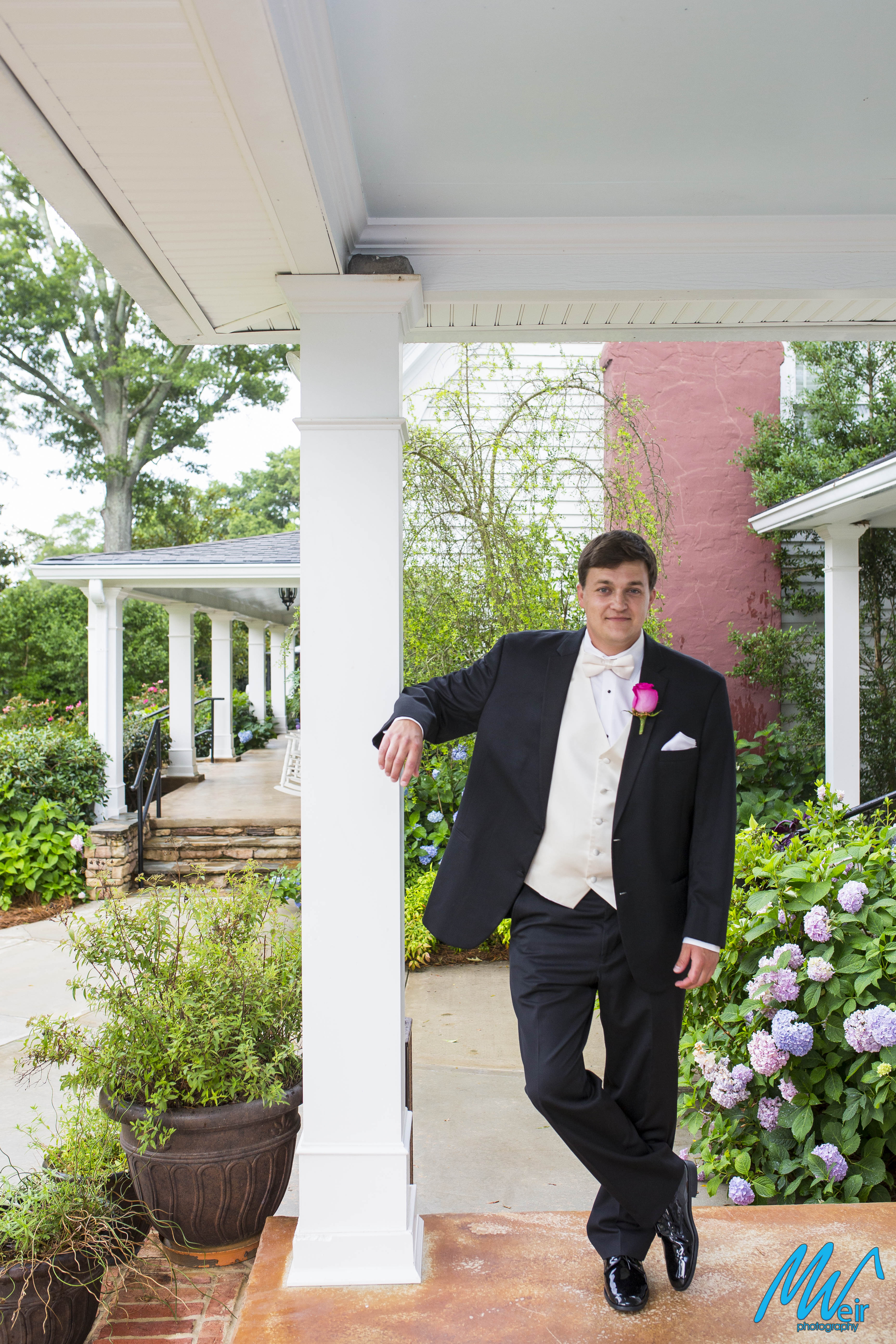 groom standing on porch