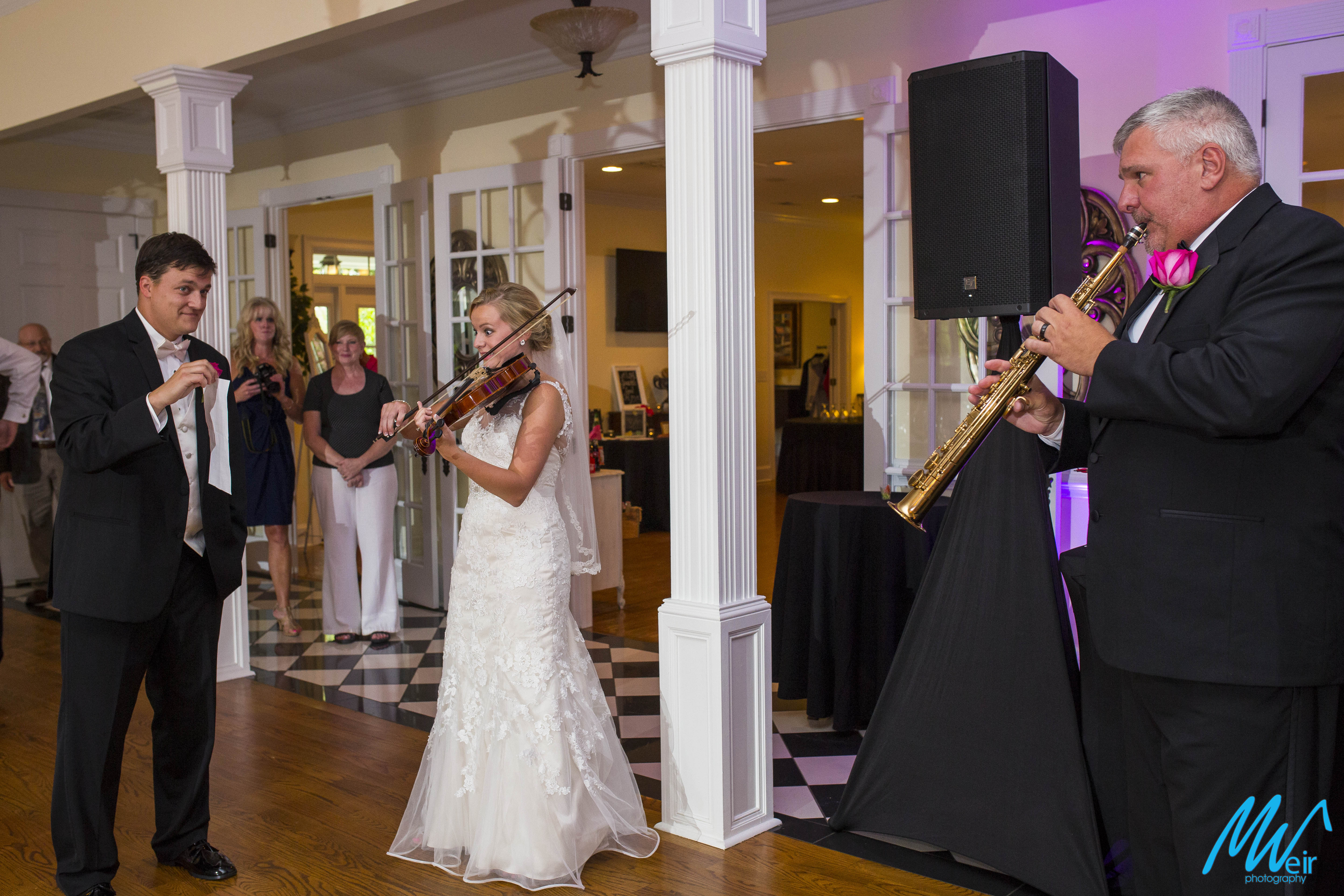 bride plays violin and father of bride plays clarinet during a duo