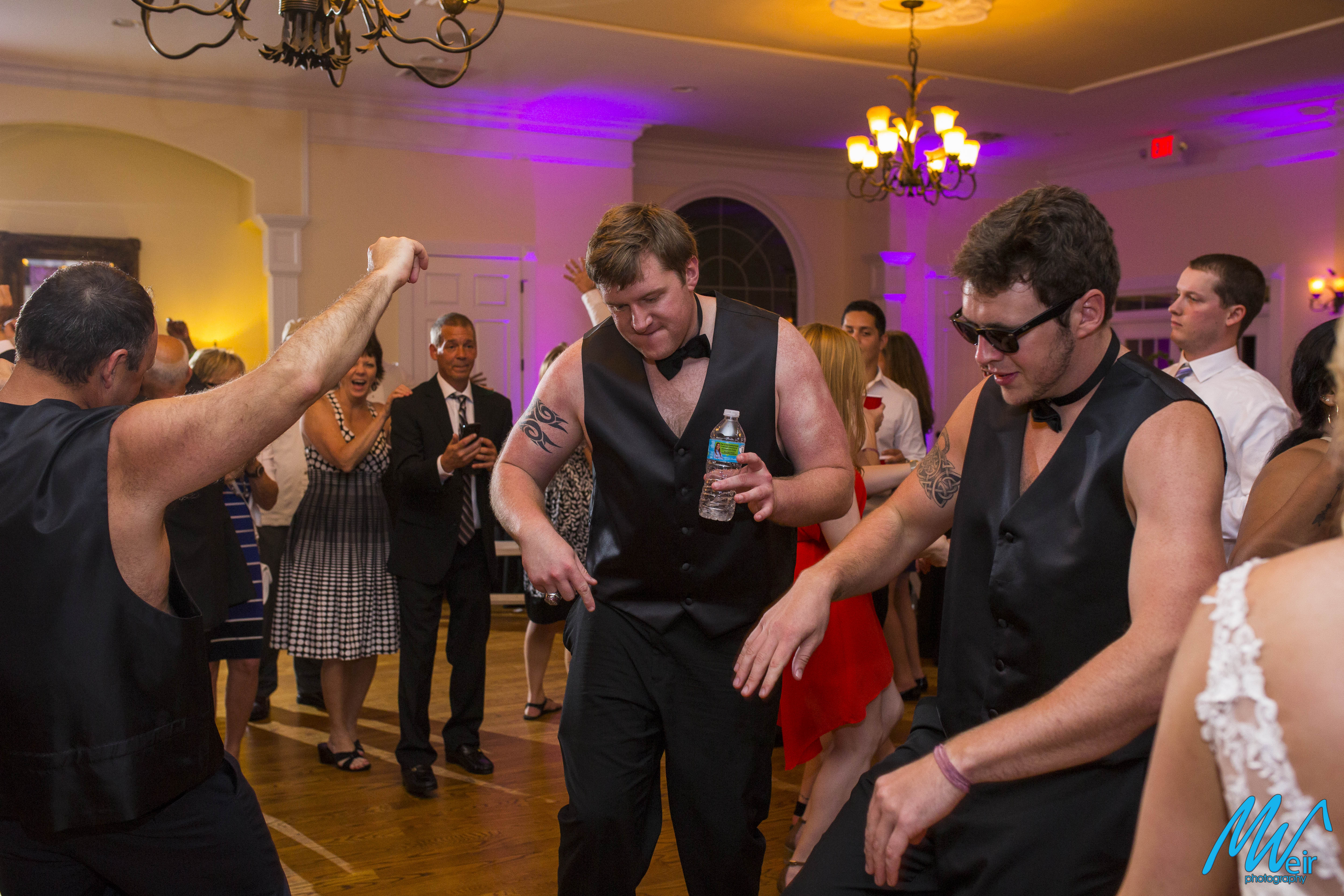 men dance during reception