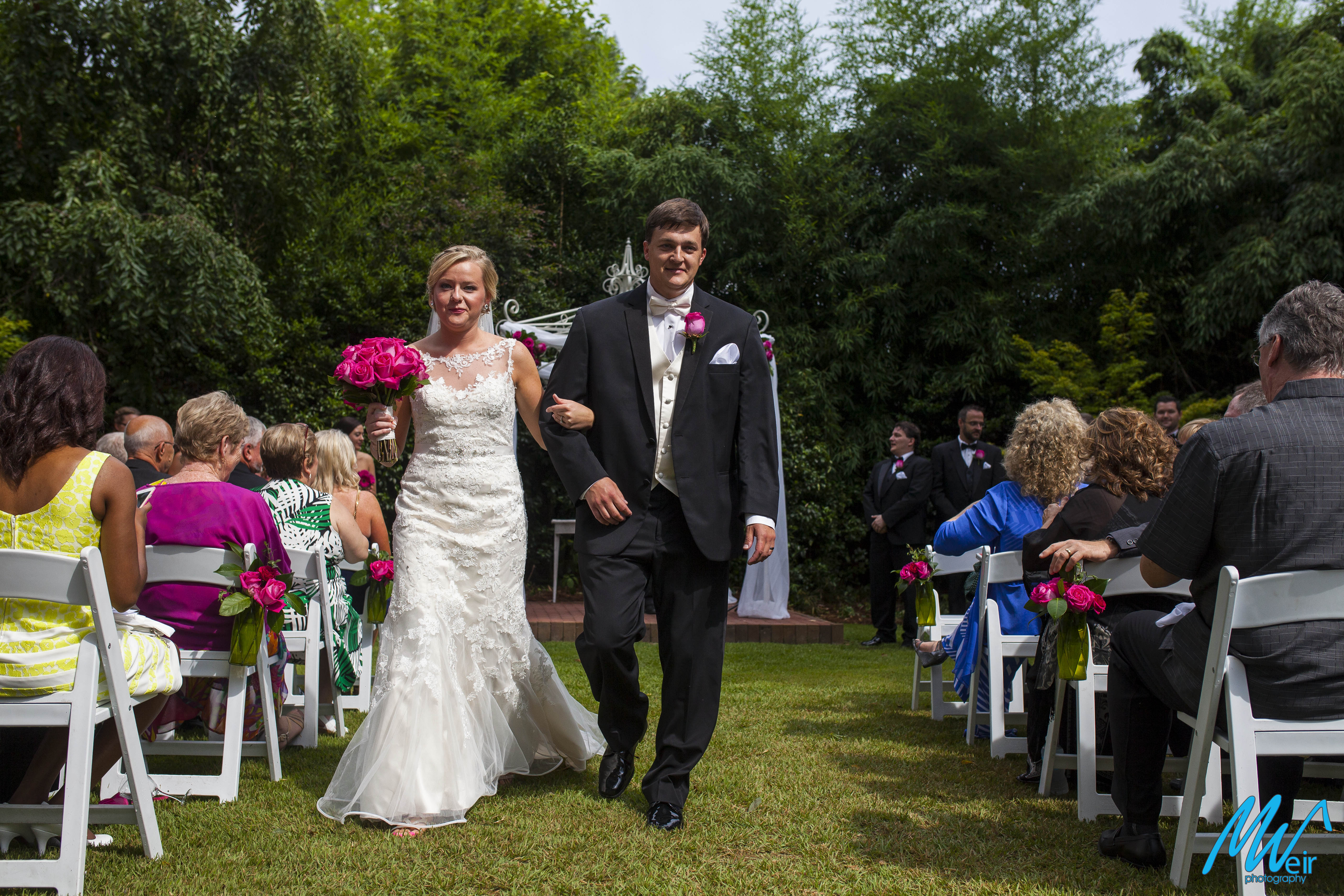 bride and groom walk back up aisle after ceremony