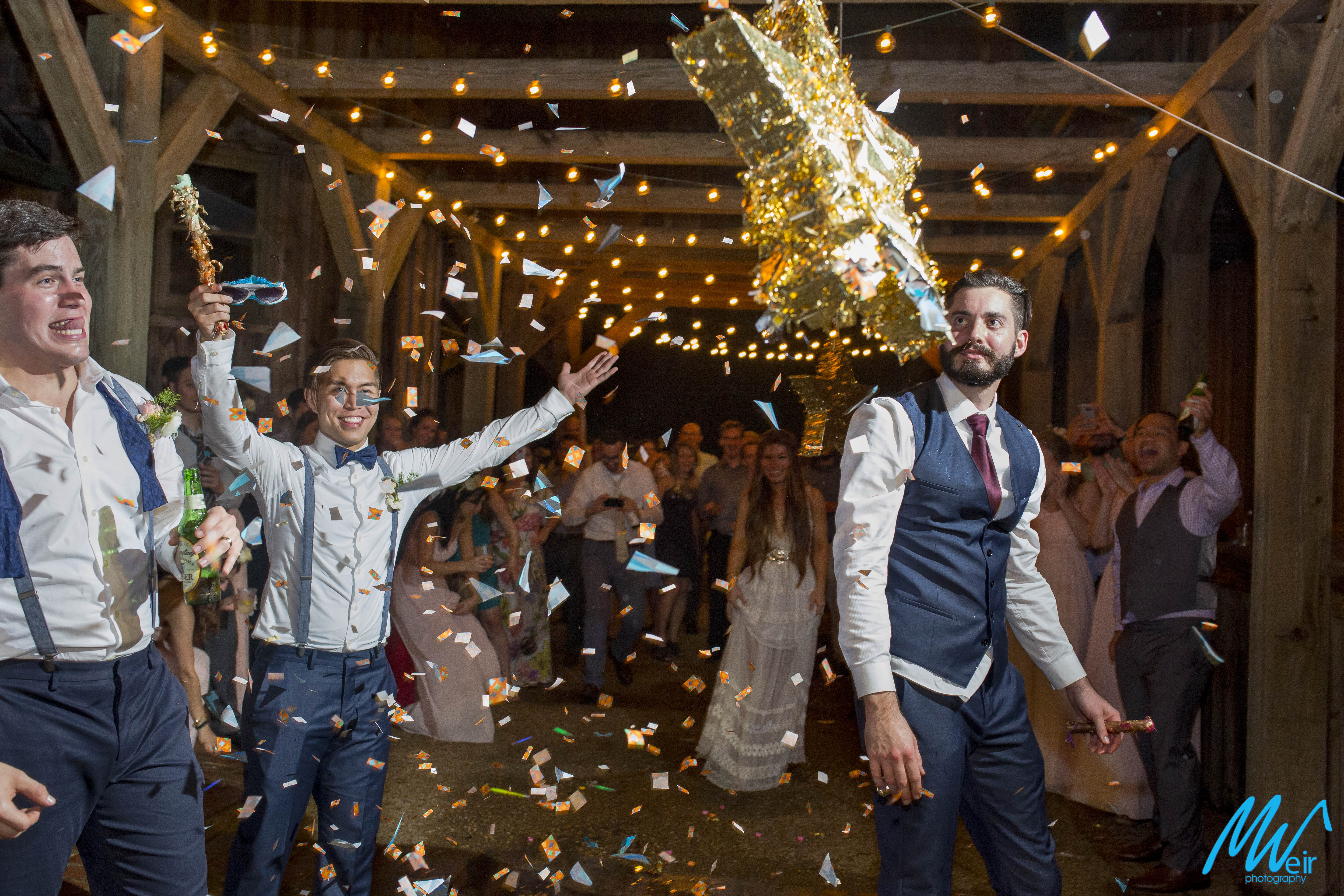 groom busts through pinata and gets rained on by confetti