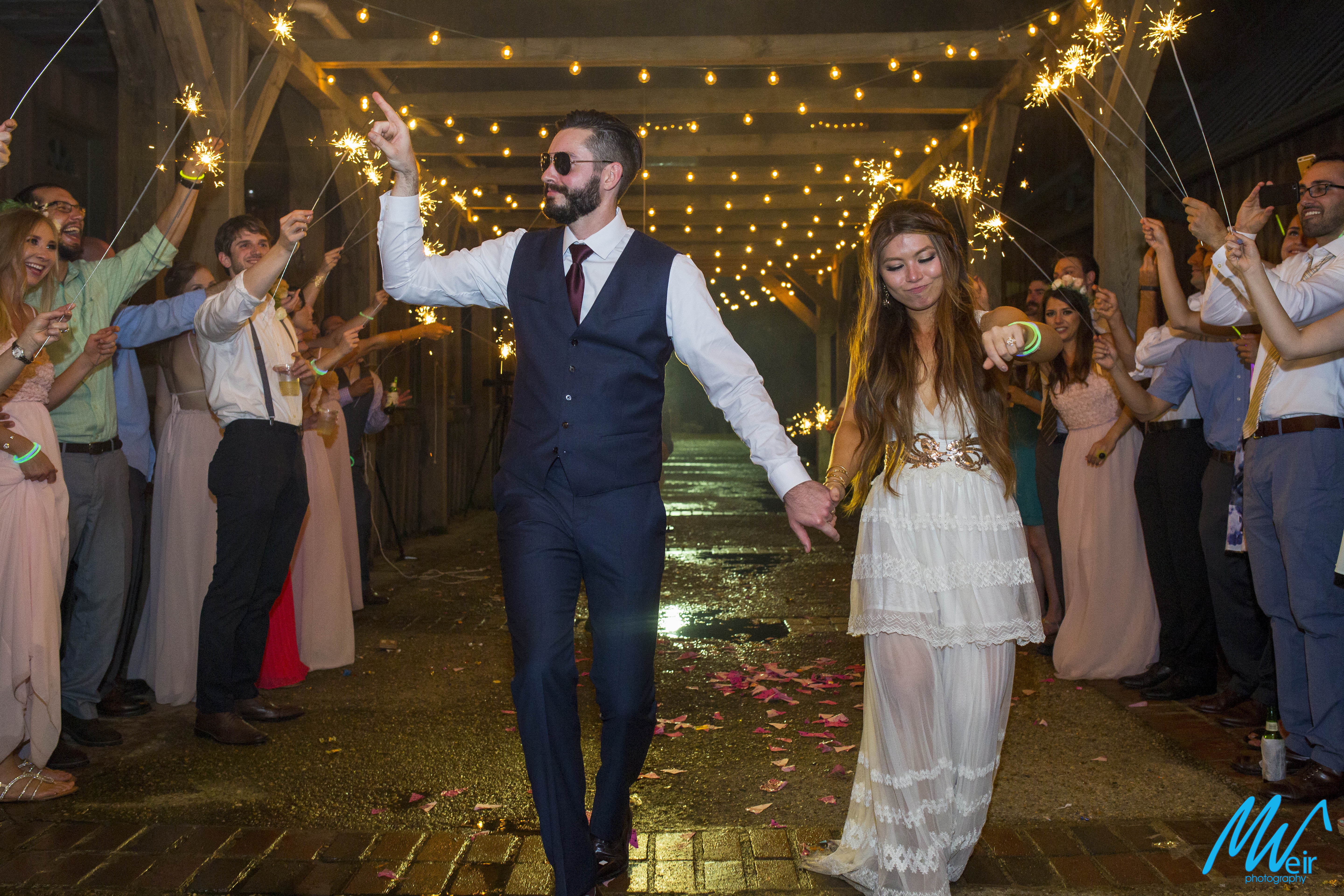 bride and groom dance during their grand exit with sparklers