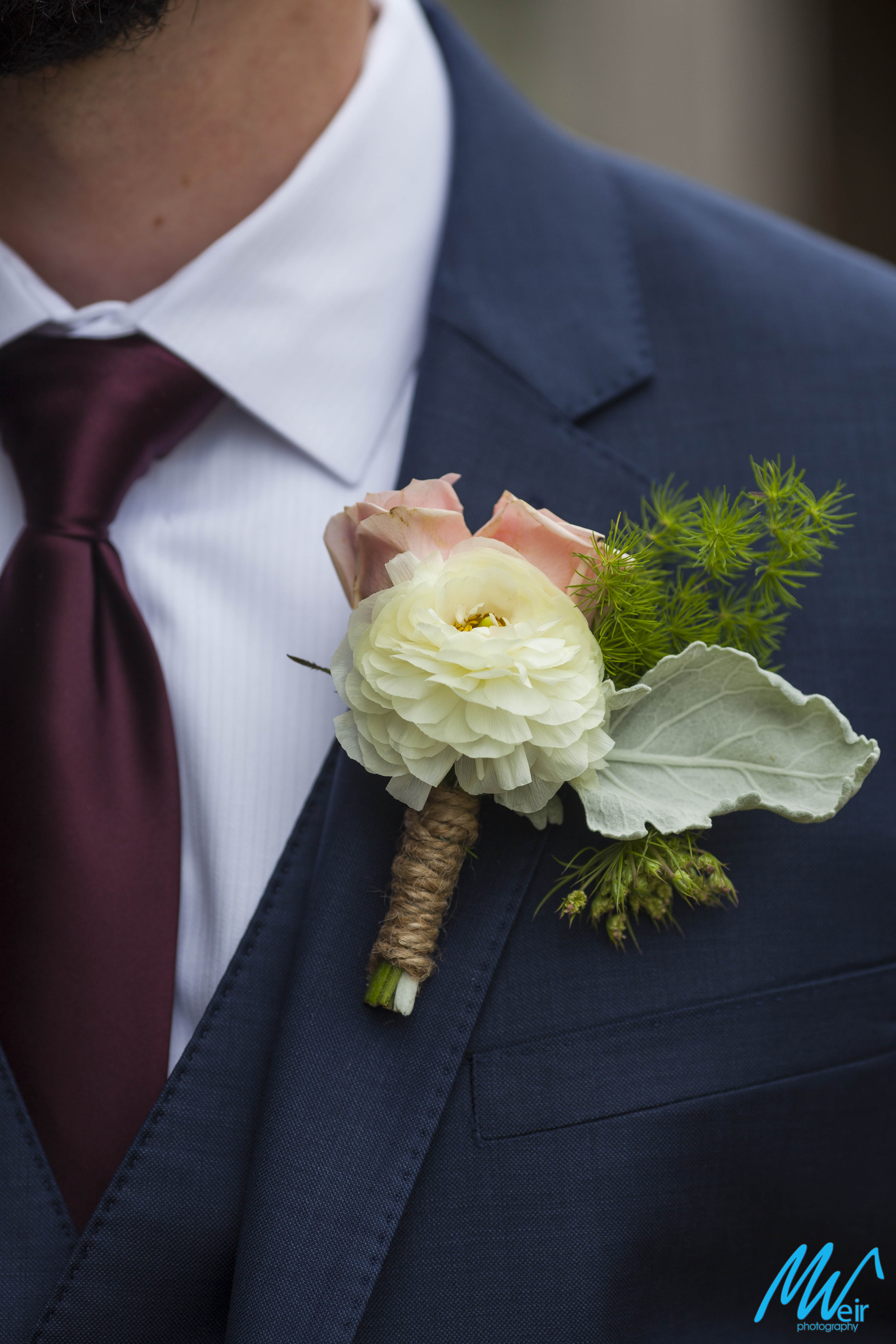closeup detail of grooms boutonniere 