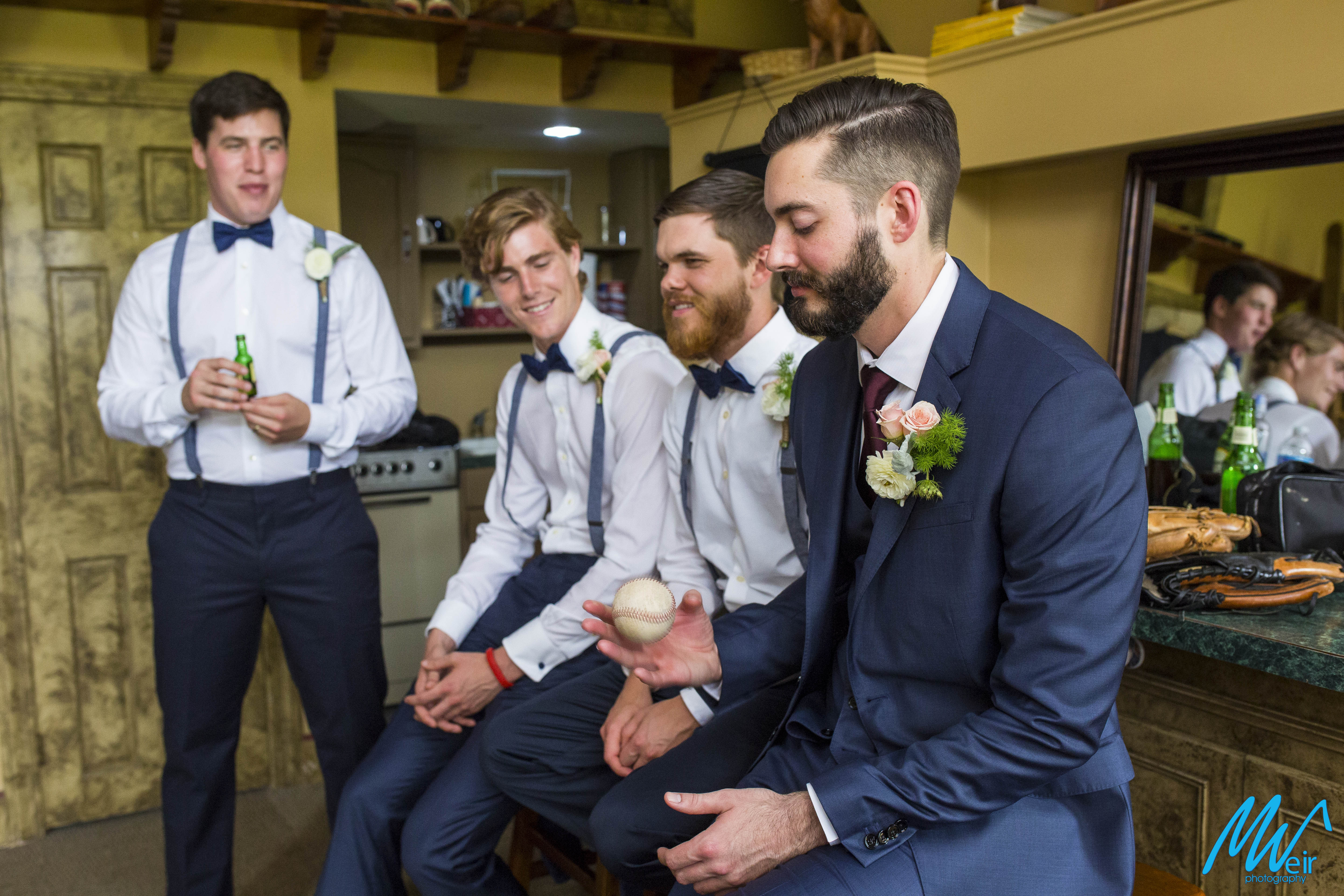 groomsmen hang out in grooms suite before ceremony