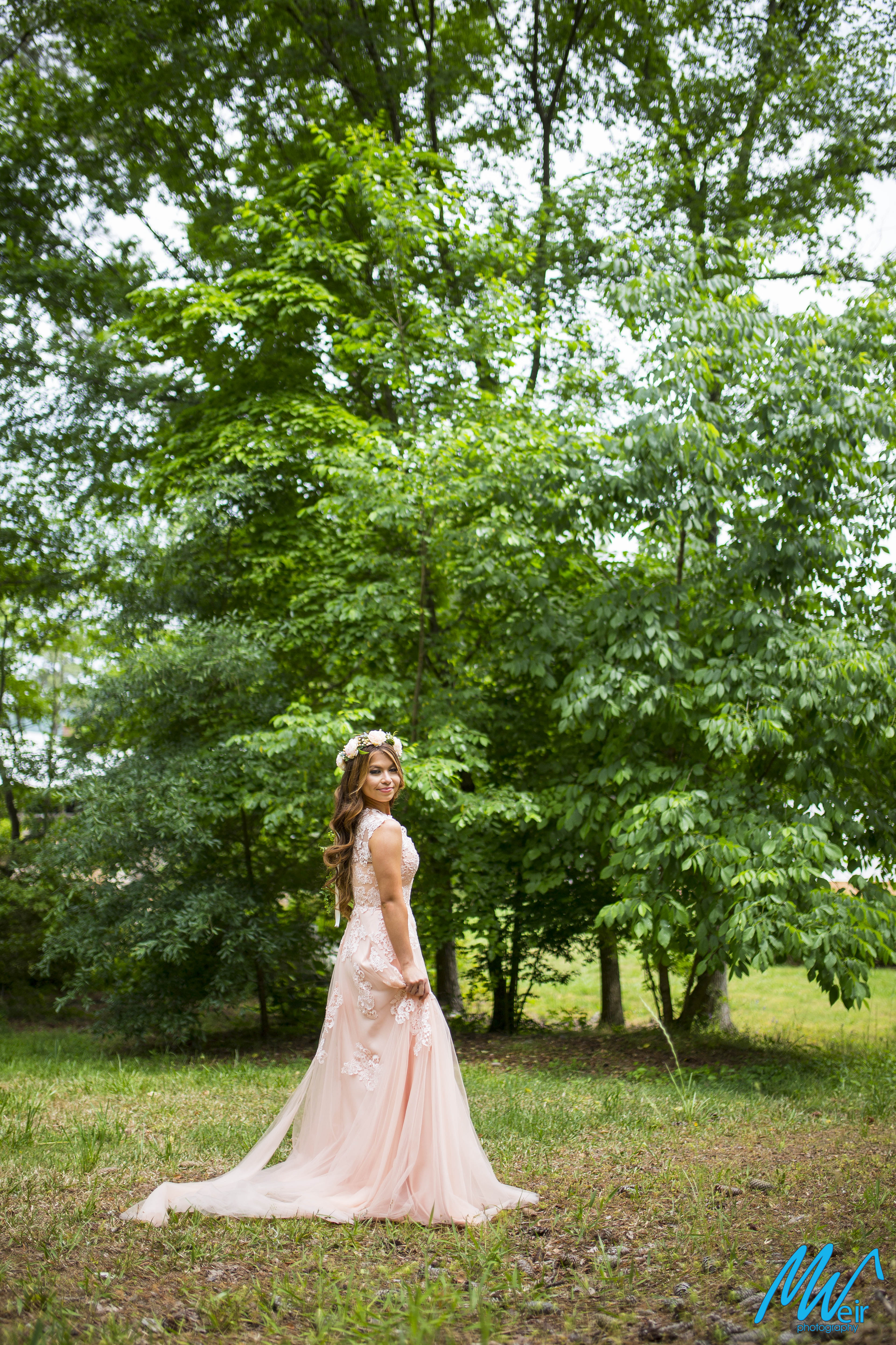 bride standing in a field
