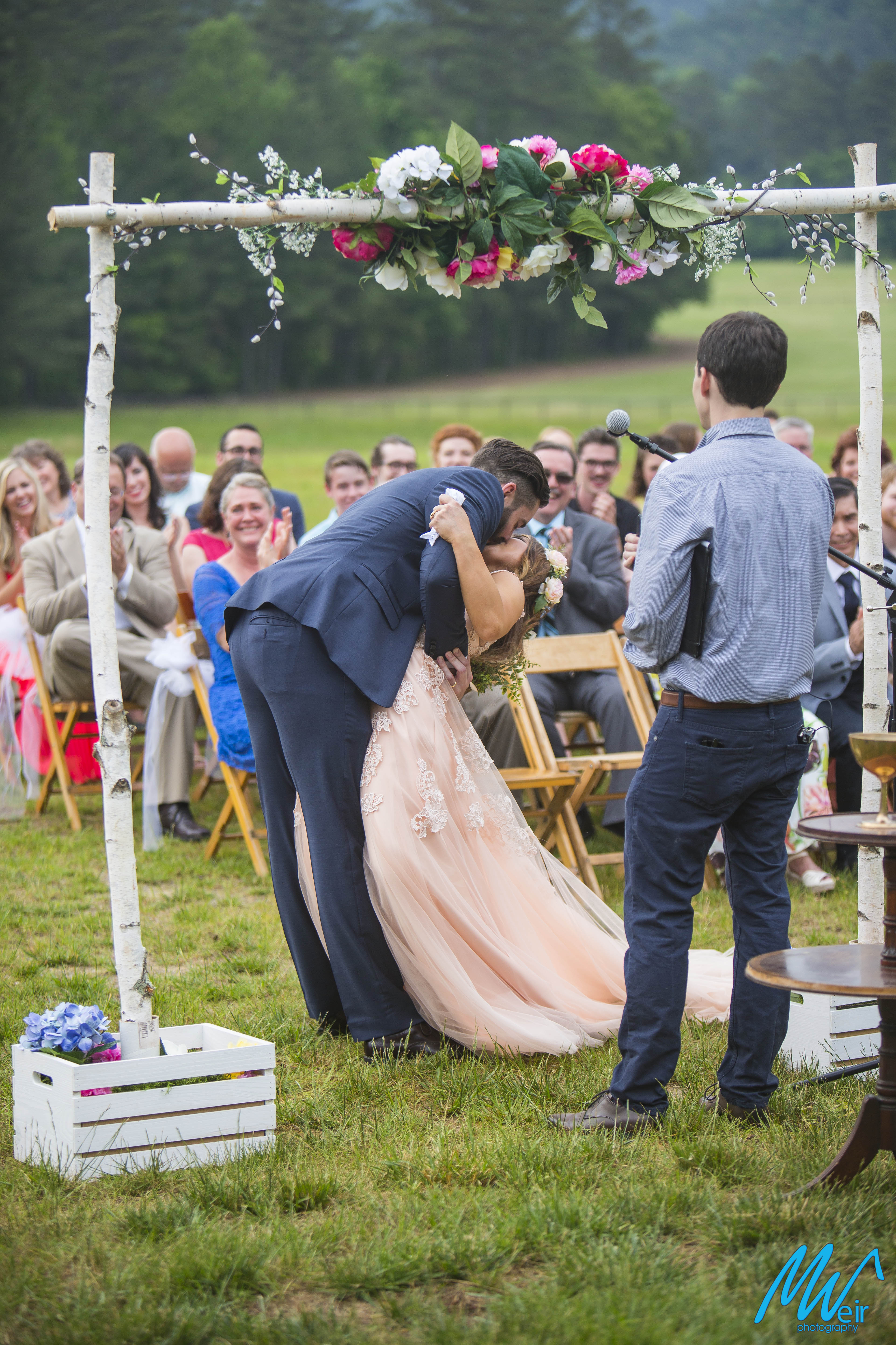 Bride and groom share a back bending first kiss as husband and wife