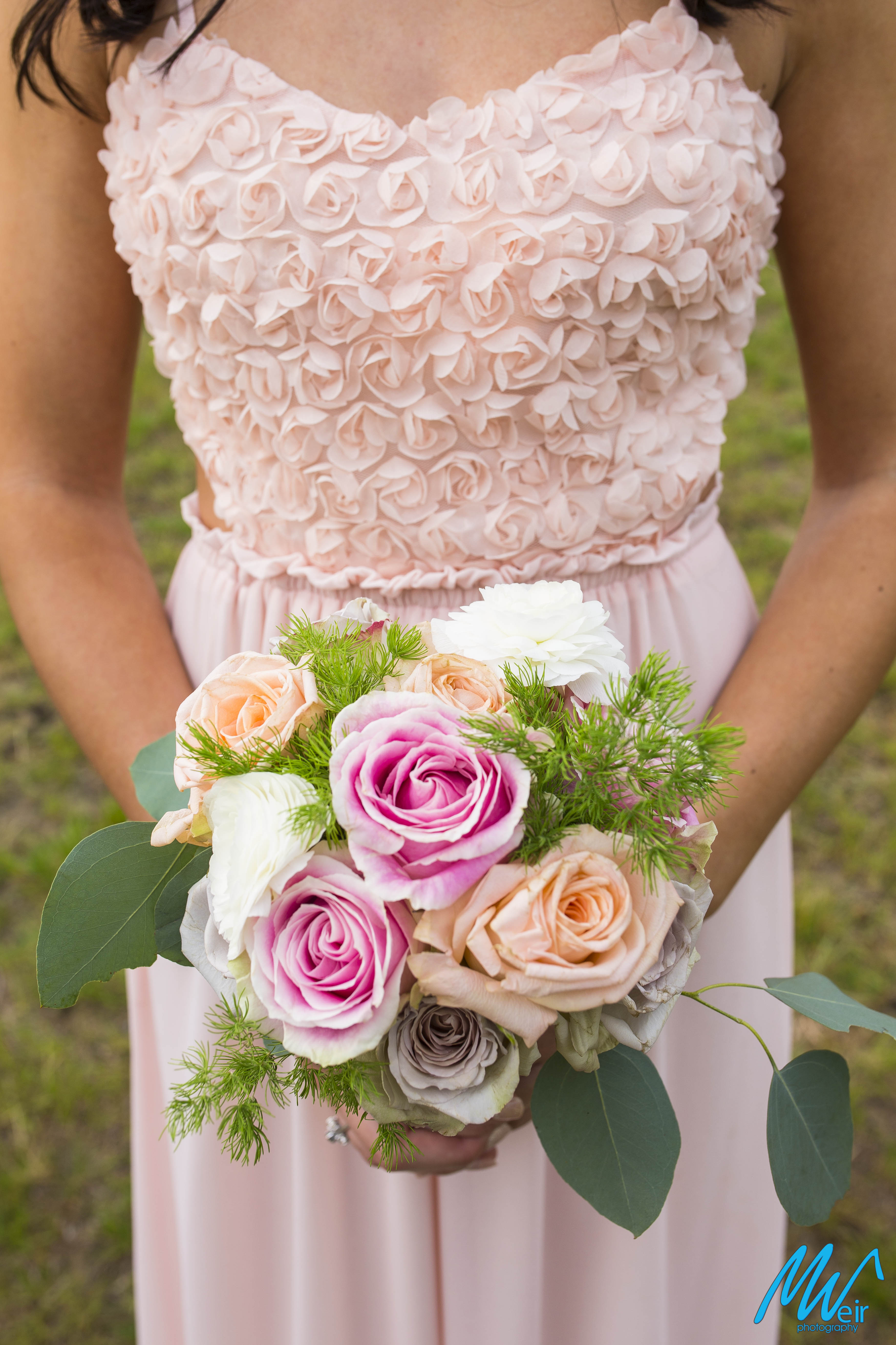 Pale pink bridesmaid dress with pink rose bouquet