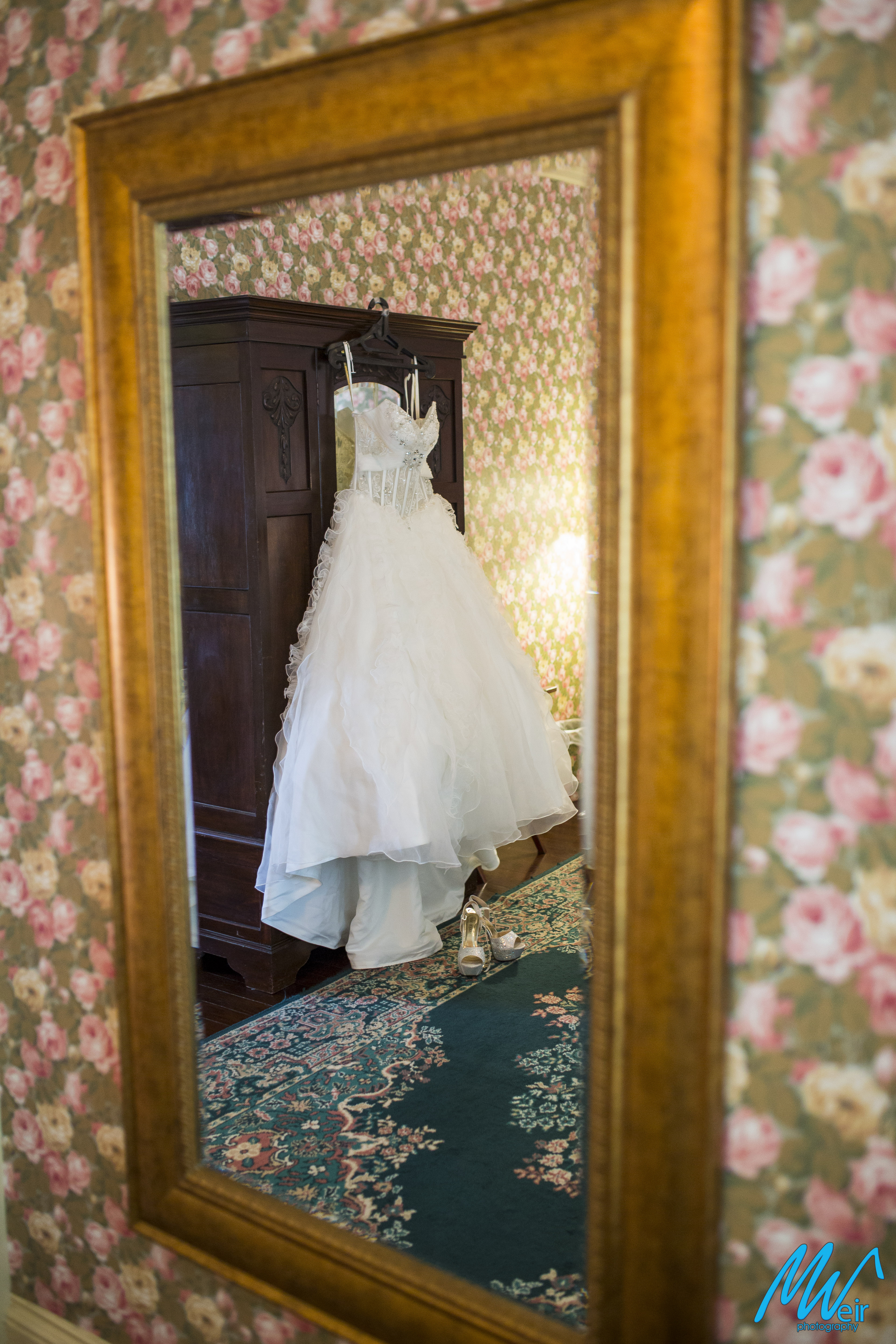 Bride's white wedding gown in the mirror