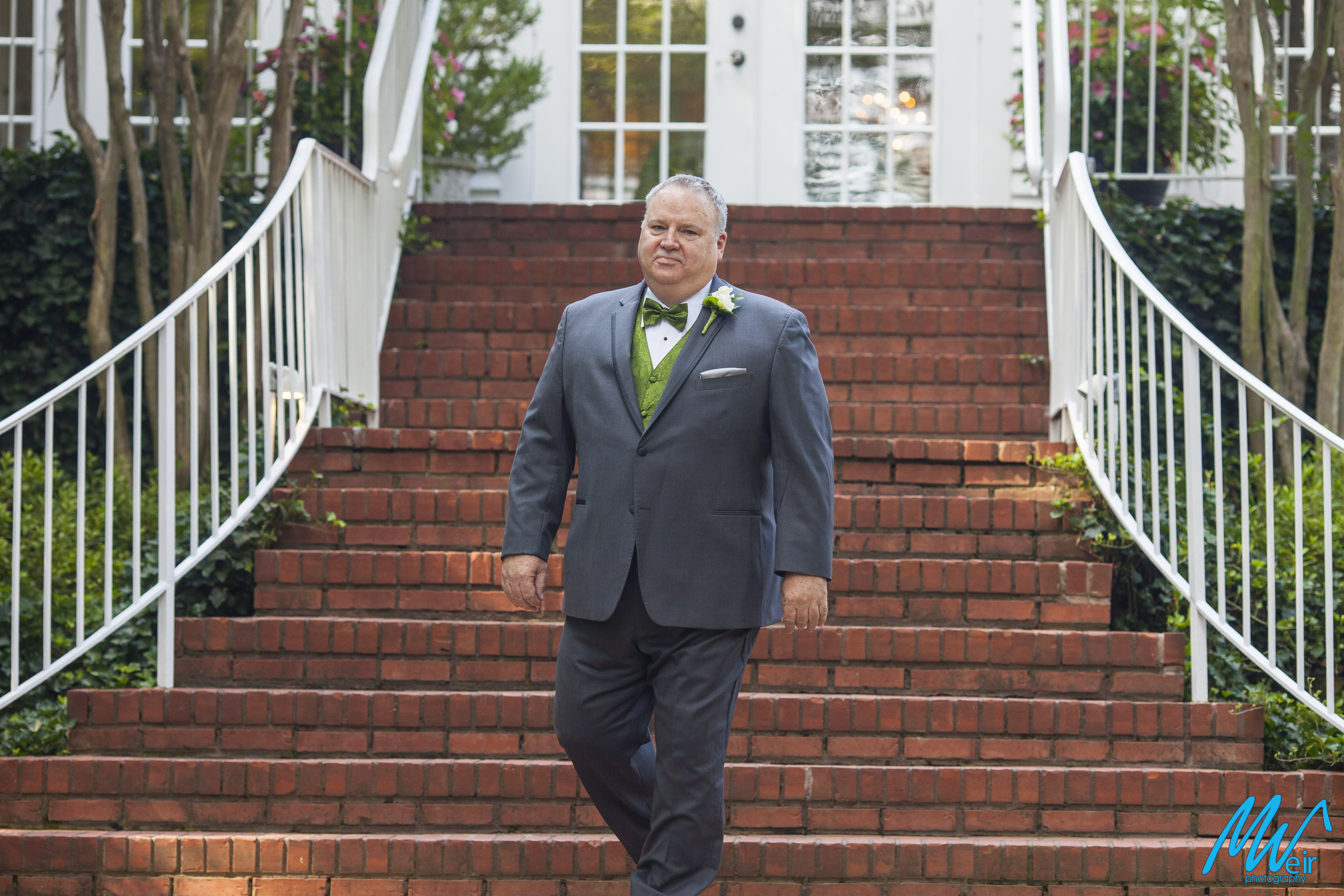 groom walks down the aisle at wedding ceremony