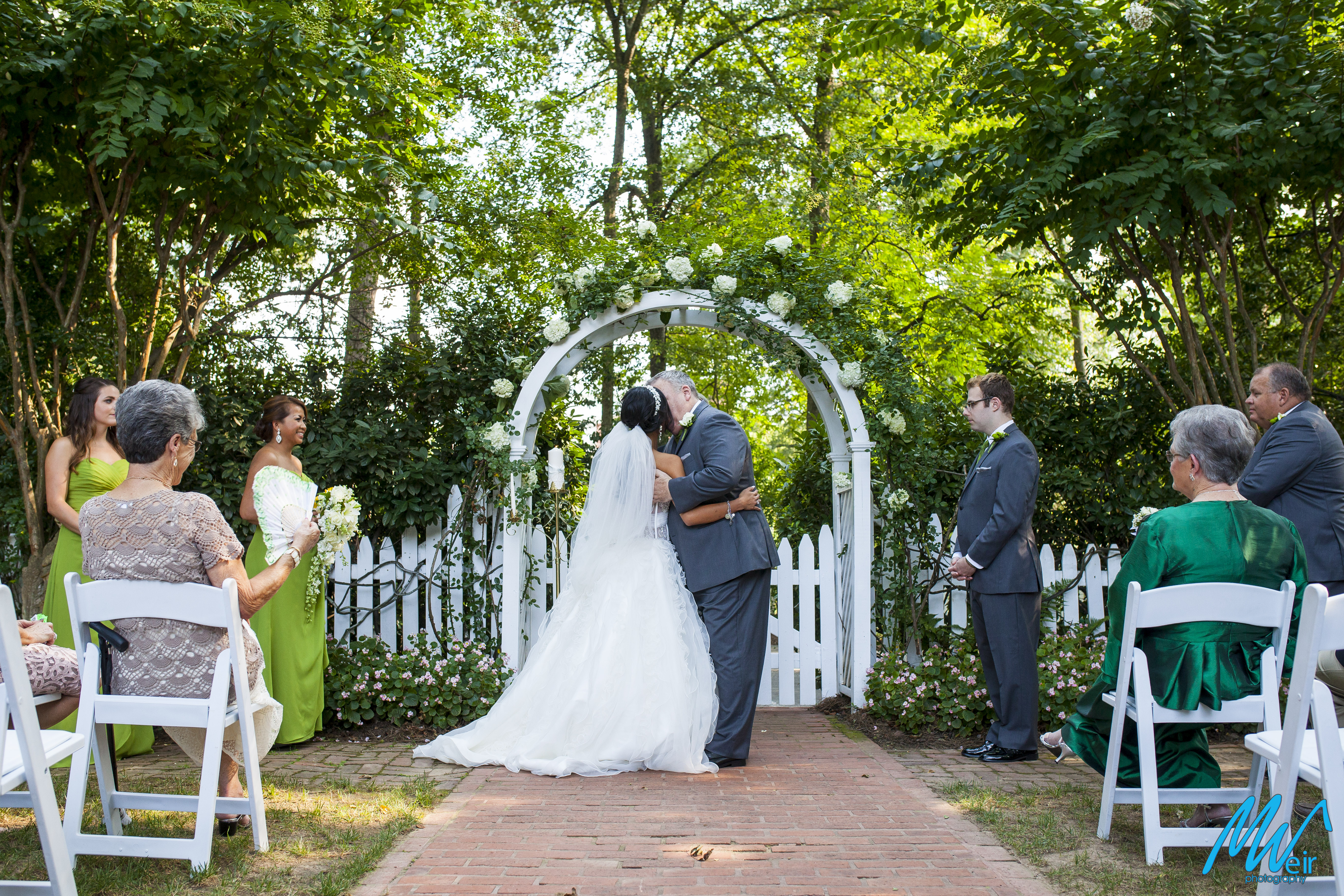 bride and groom share a first kiss as husband and wife