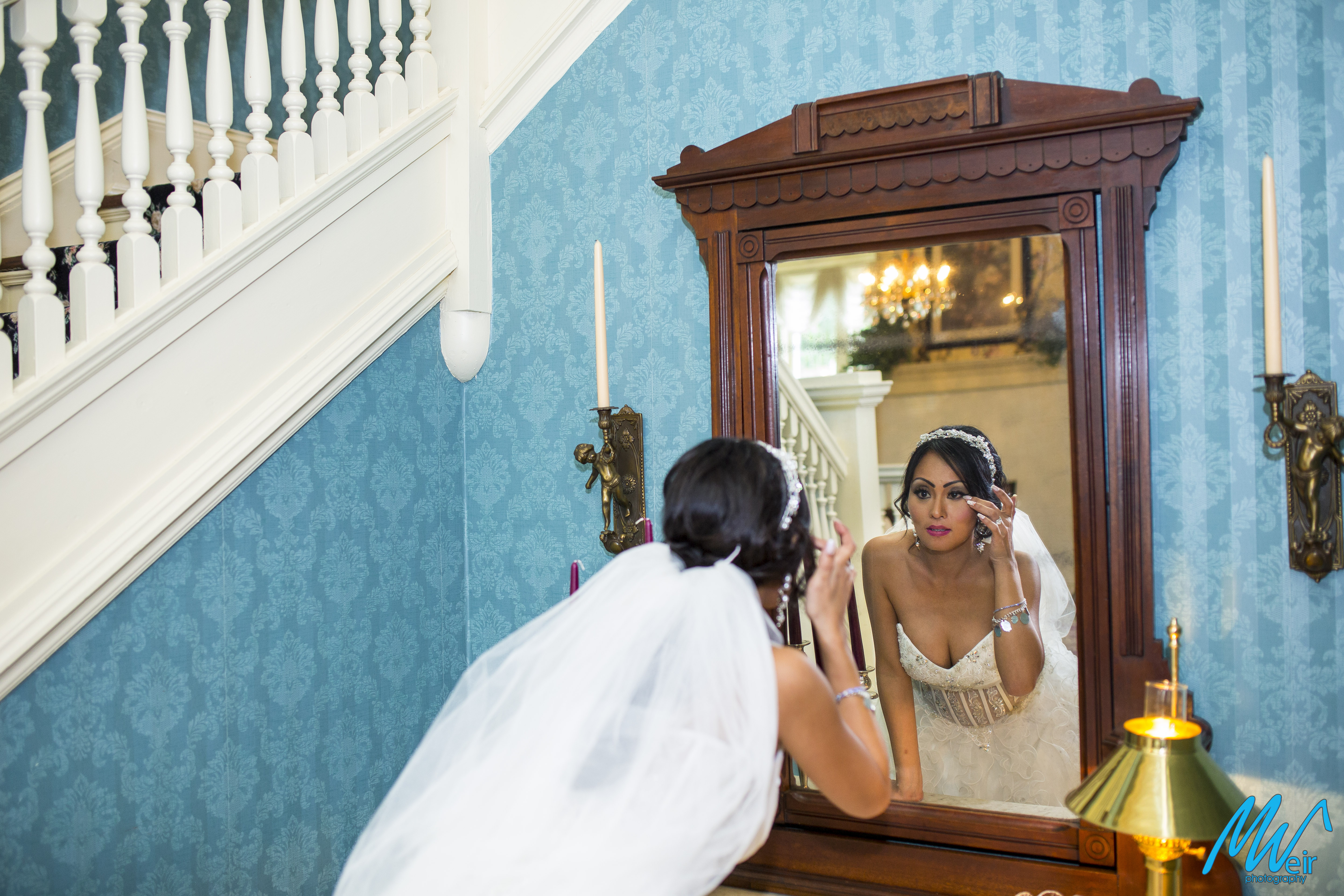 bride checking her makeup in the mirror