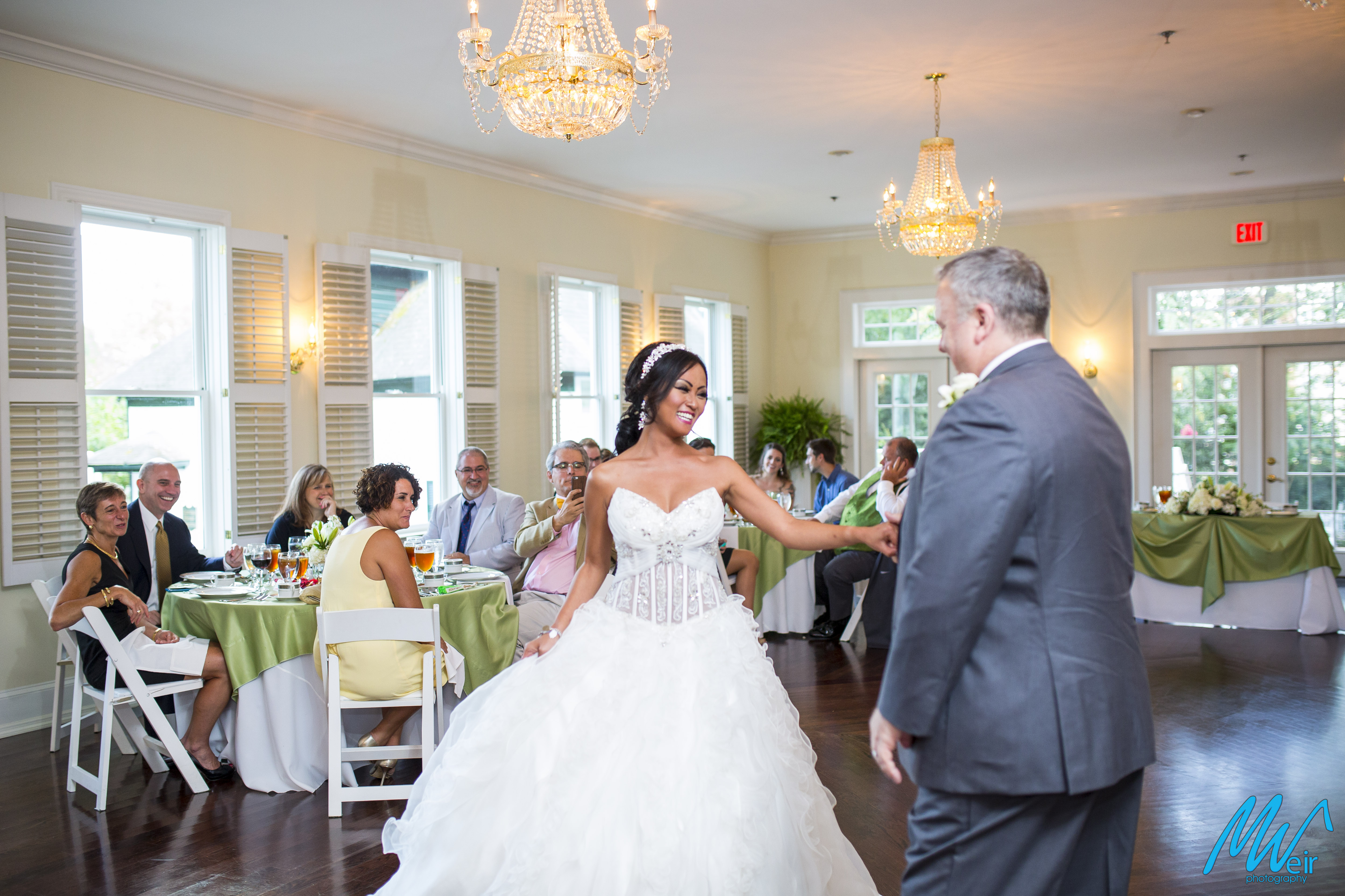 bride looks like a princess as her new husband twirls her during first dance