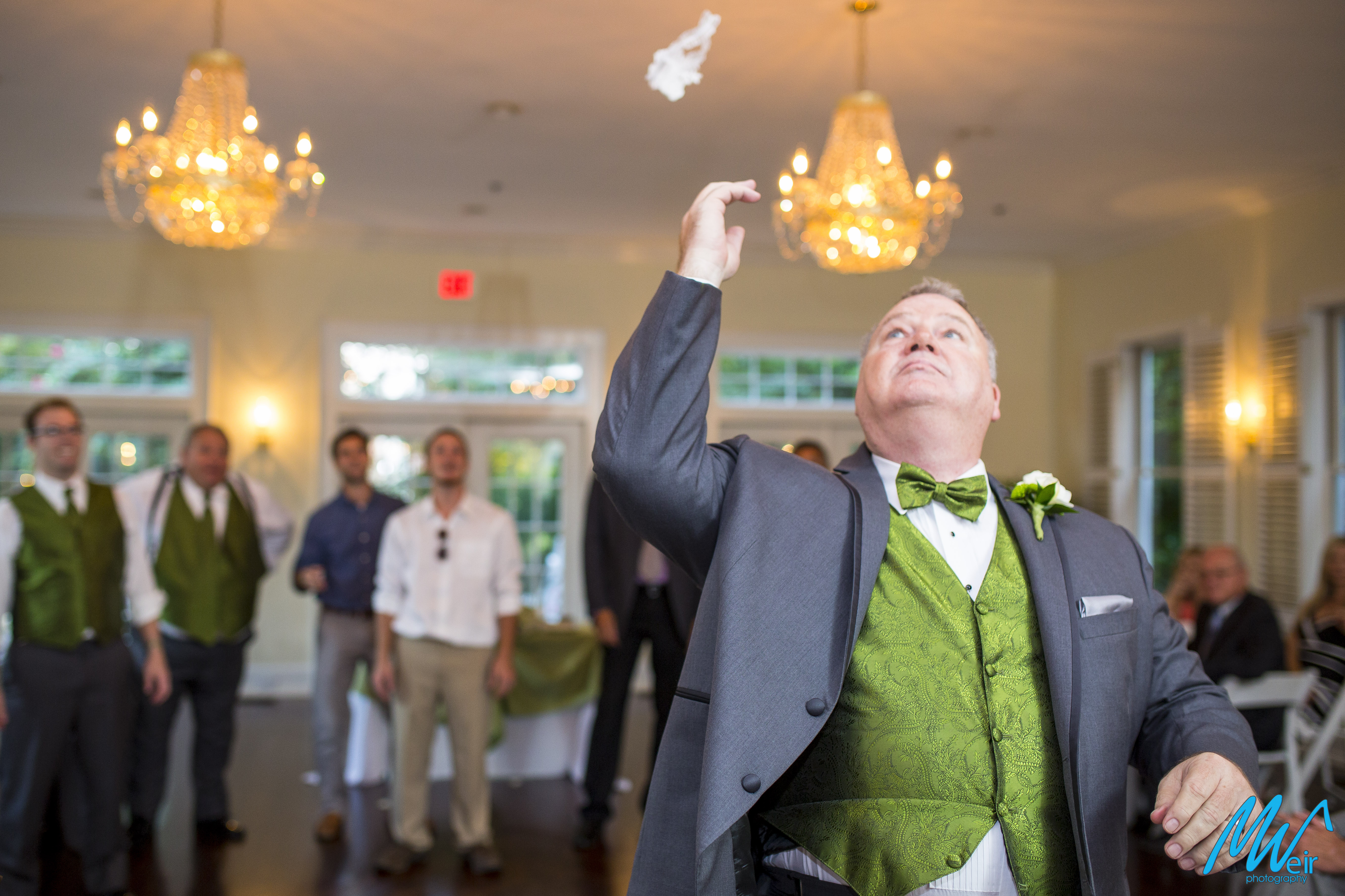 groom throws the garter to single men
