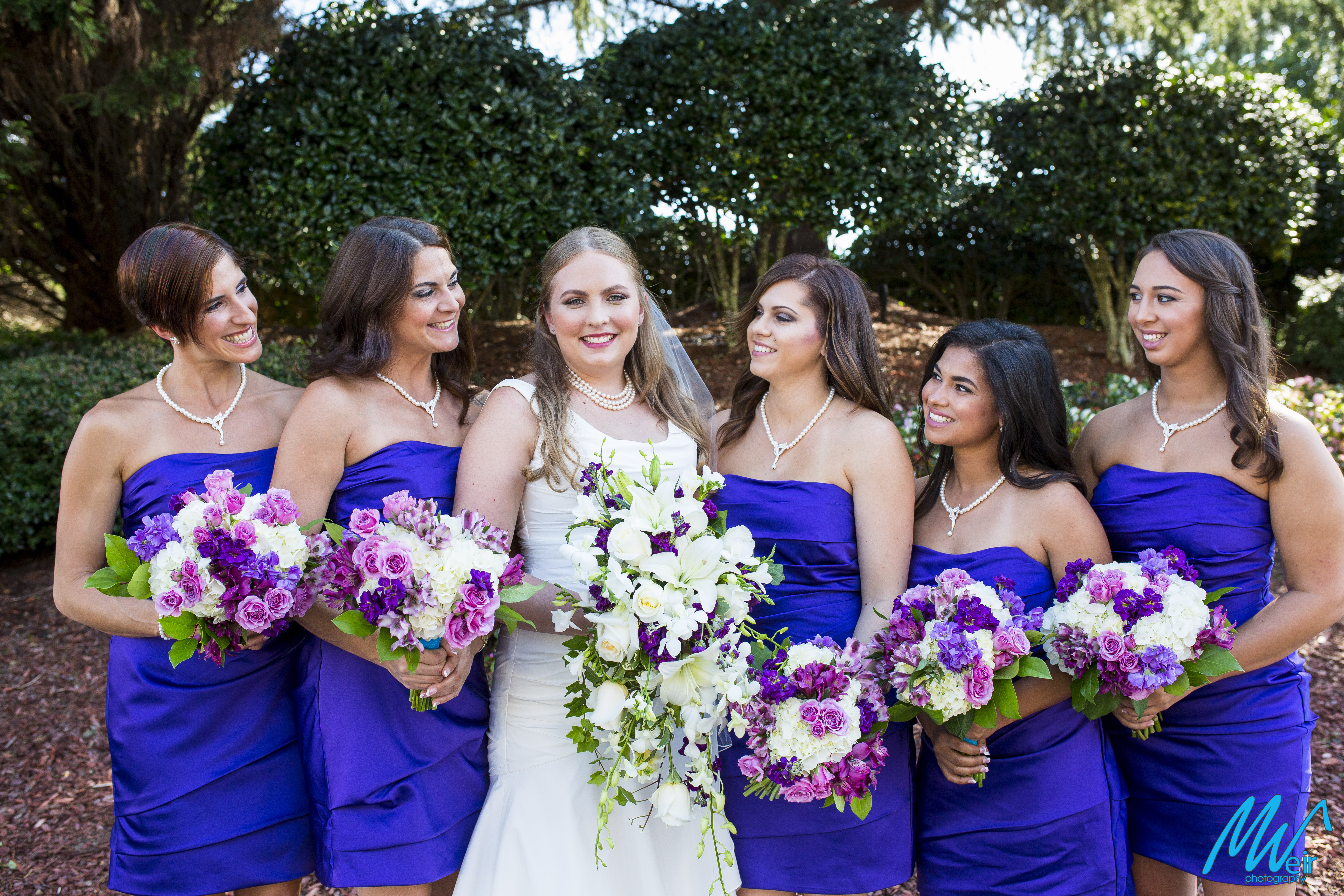 bridesmaids gaze at beautiful bride