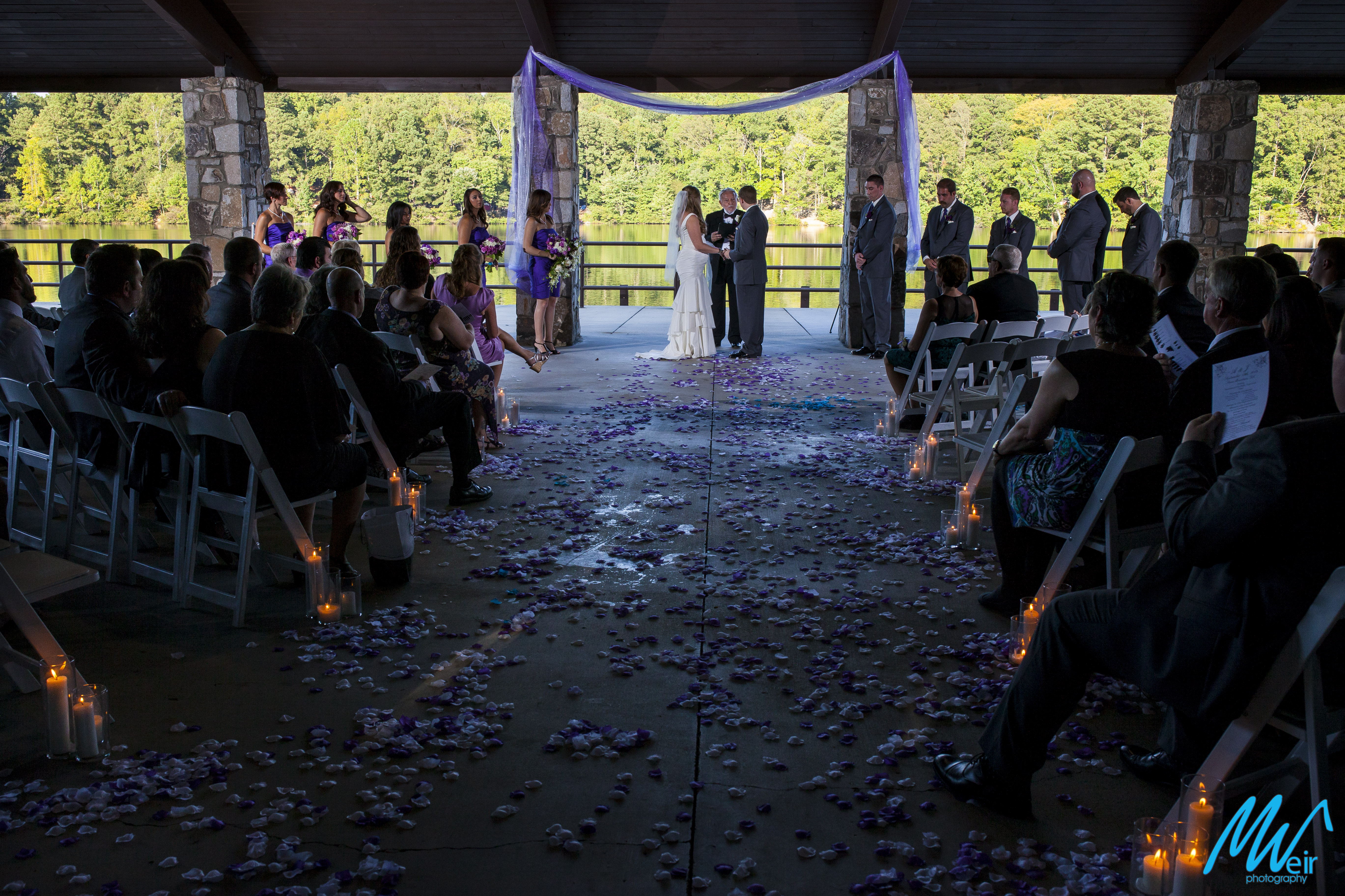 wide angle photo of bride and groom standing at alter during wedding ceremony