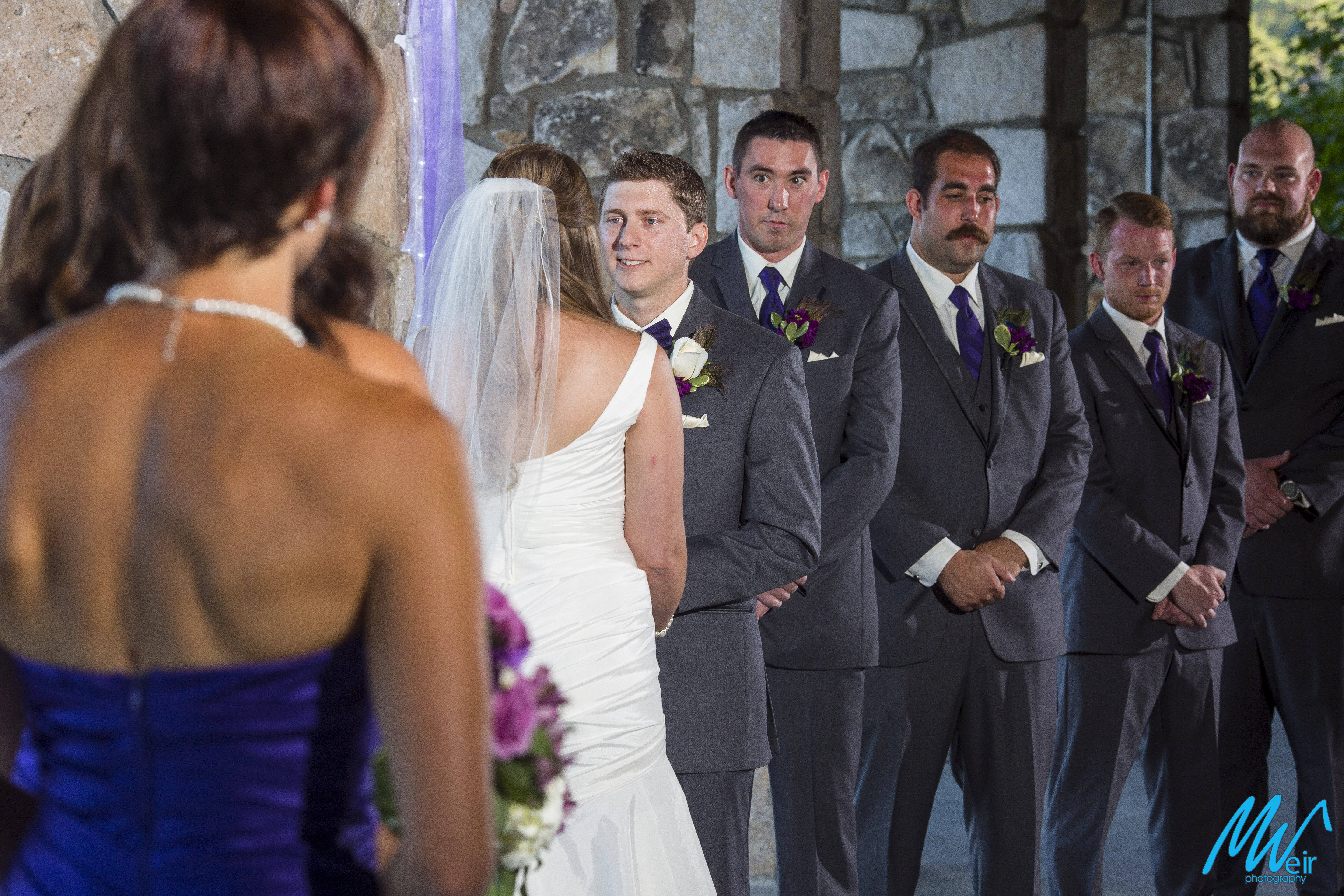 groom looks at bride during wedding ceremony