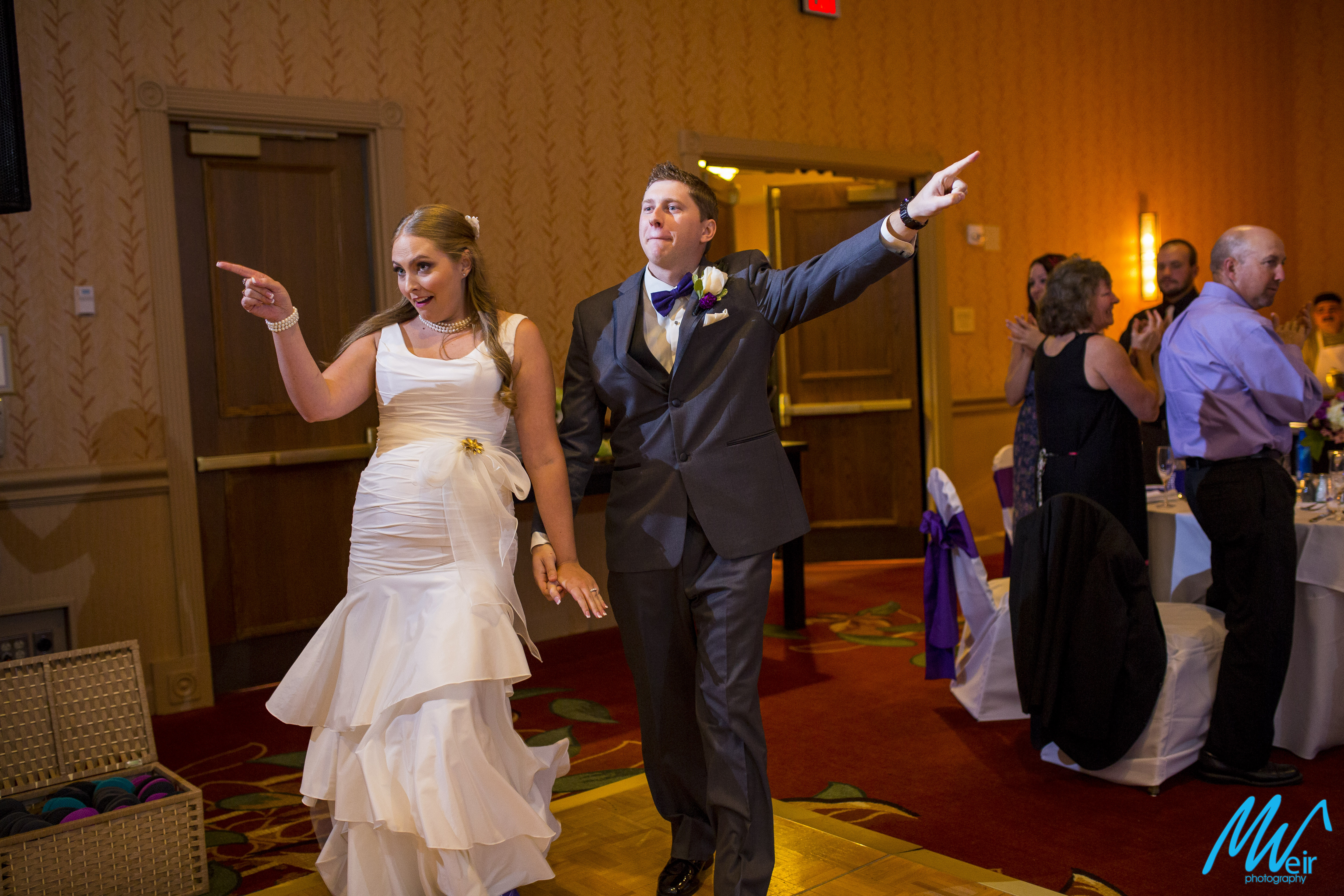 bride and groom make a grand entrance into their reception