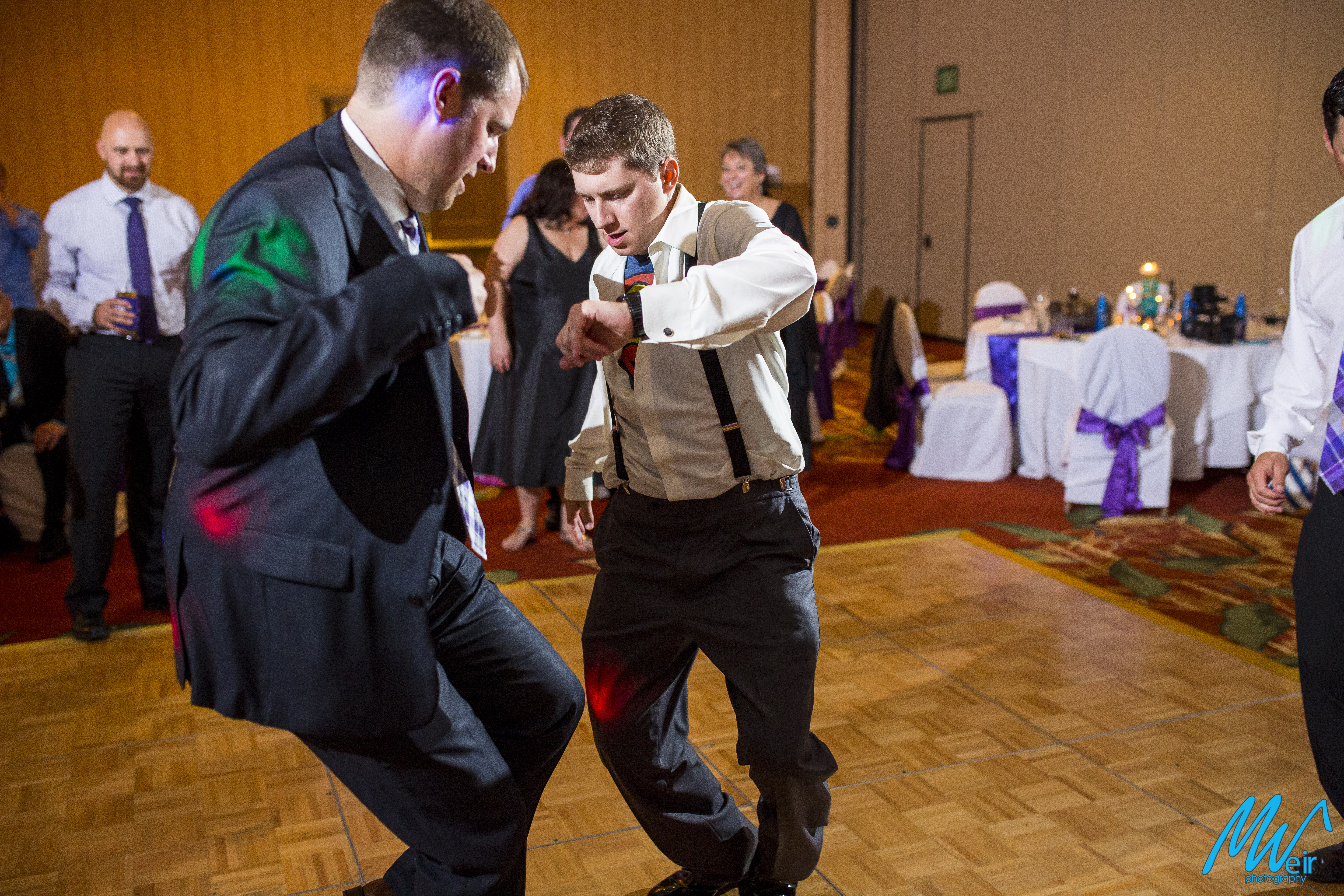 groom and groomsman intense dancing during wedding reception