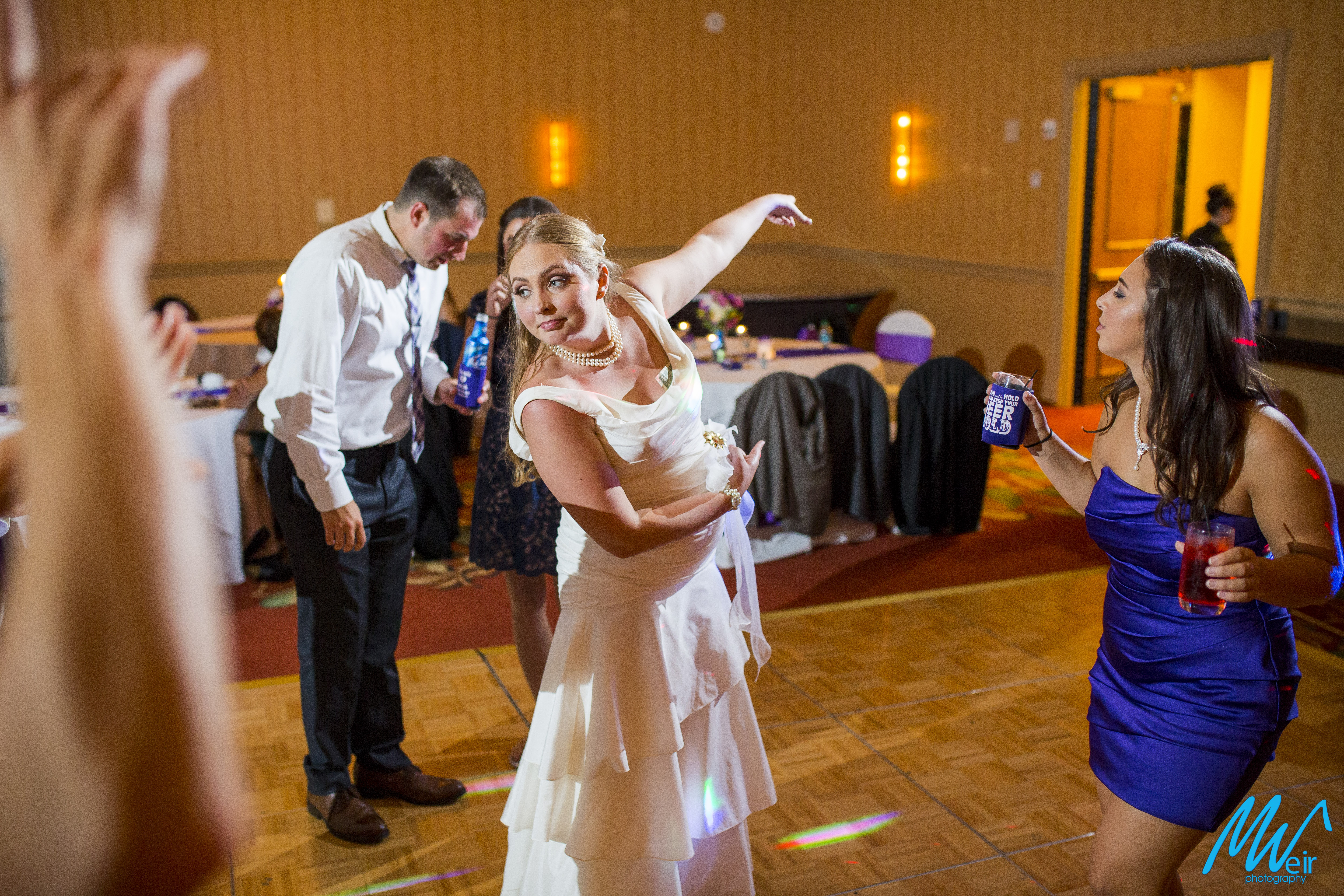 bride points to the door during reception dancing
